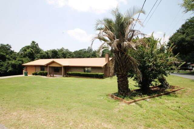 Older home in excellent location that has been well maintained and is in good condition and being offered ''as is''. The property includes all of Block 35 which is 8 lots and equals 1.42 acres on the CORNER of Hickory Ave. and 46th St. Home features all brick construction with a metal roof. Very large screened porch across the back overlooks the lush back yard. Huge great room with fireplace and a wet bar. 3 bedrooms and two baths. Large formal front room that could be used for a living or dining room. Spacious dining area off the kitchen. Lots of storage. Very large workshop with electricity and window air conditioning units. The property ID includes all 8 lots but they are separate as you can see from a photo of the plat. This home has a lot of potential with some updating.