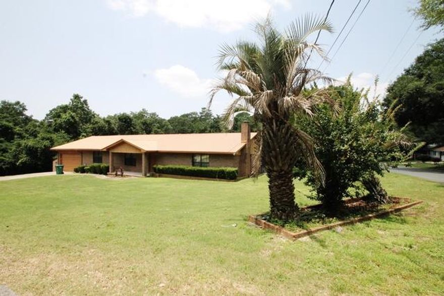 Older home in excellent location that has been well maintained and is in good condition and being offered ''as is''. The property includes all of Block 35 which is 8 lots and equals 1.42 acres  on the CORNER of Hickory Ave. and 46th St.  Home features all brick construction with a metal roof. Very large screened porch across the back overlooks the lush back yard. Huge great room with fireplace and a wet bar.  3 bedrooms and two baths. Large formal front room that could be used for a living or dining room. Spacious dining area off the kitchen. Lots of storage. Very large workshop with electricity and window air conditioning units. The property ID includes all 8 lots but they are separate as you can see from a photo of the plat.  This home has a lot of potential with some updating.