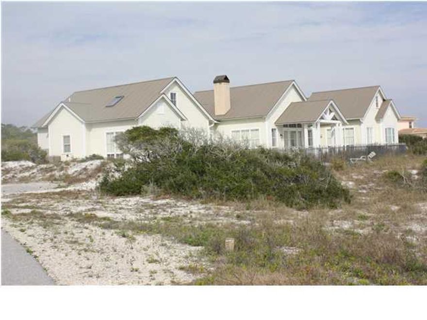 Rare opportunity to own a beautiful Gulf view home in the private, gated community of Four Mile Village! Preserved by the Coffeen Land Trust, Four Mile Village has been created, planned and kept in existence on the basis on long-range protection of its unique goals and principles of retaining its beauty, quietness and peacefulness. Once you pass through the gated entrance, you know you are in a special place! Conveniently located close to restaurants, shopping and attractions, yet you feel world's away from it all! The protected dune environment is unlike any other in the area and is close to the way it was a hundred years ago! This beautiful five bedroom, four and one half-bath custom home is situated on a bluff overlooking the Gulf with over seven acres of unobstructed view that