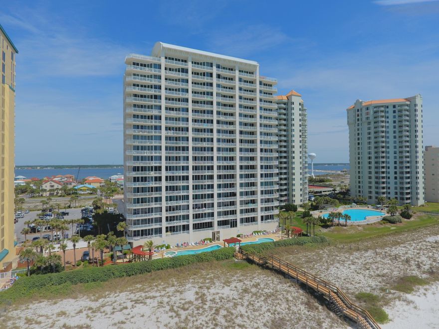 Just Reduced $5000. This is a stunning Gulf front 2 bedroom, 2 bathroom unit located in the gated community of The Pearl of Navarre. The kitchen, dining, and living room are open and spacious and lead the way to the expansive balcony overlooking the beautiful Gulf of Mexico. Listen to the waves as you make a beverage at the wet bar complete with wine refrigerator and enjoy magnificent sunsets from your generous balcony. Wake up and fall asleep to the sounds of the ocean from the Gulf front Master Suite which features floor to ceiling glass doors that are perfect for taking in the boundless views of the white sandy beaches and Gulf of Mexico.
The Pearl of Navarre is a gated community with 2 gulf front swimming pools, hot tub, exercise room, conference room and community beach walkover. Navarre Beach is one of the last places with the old Florida feel with quaint beaches, biking and walking paths, fishing pier, Gulf Island National Seashore and more.