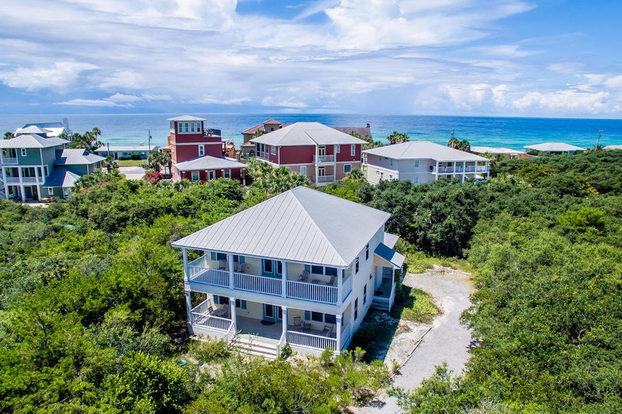 LOCATION. LOCATION. LOCATION. This beautiful 4BR/2BA, 2036 sq.ft. beach house, with over 1100 sq.ft of porches, is located on a quarter acre lot in the desirable Blue Mountain Beach community and within 250 yards of the beach access. Spacious open-concept living space with hardwood floors, built in bookcase and lots of windows. Kitchen has granite breakfast bar and countertops with wood cabinets and a large, deep kitchen sink with chrome faucet. The tile floor runs throughout the kitchen, laundry room & handicap accessible bath on the 1st floor, including a shower that accommodates a wheelchair. The 4th bedroom on the 2nd floor would make a great bunk room. This house has never been rented. Great investment property or 2nd home. The lot is big enough for a pool and deck.