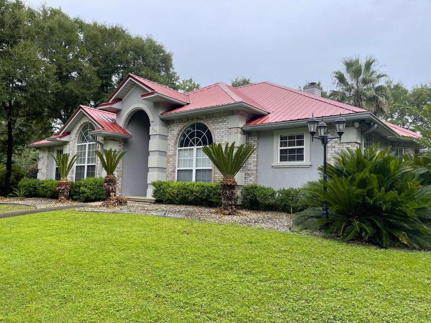 A stunning home! Built in 1999, this stylish home has 3 bedrooms 2 and 1/2 baths and is right at 2458 square feet. Located on 1.06 acres, this home has all brick exterior with stucco high lights, side entry 2 car garage . A corner lot home with privacy fenced back yard, large screened gazebo, and many varieties of palm trees throughout the property. Inside, Brand new LVP flooring through out and tiled floors in wet areas. Home has been completely painted to include walls and ceilings , large sunroom/bonus room and split bedroom design. Metal roof and brand new AC unit. With a circle drive for additional character and appeal, This is definitely one property you will not want to miss.