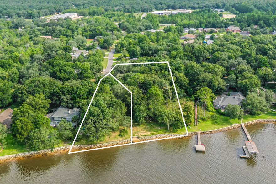 Welcome to your future home site! These beautiful vacant lots, 9 & 10, come with a combined 214 feet of serene waterfront on just under an acre, providing the perfect backdrop for your dream home. Recently bush hogged, the property features beautiful trees and a canvas for you to build upon.Situated on a generous two parcels, this lot offers a unique blend of natural beauty and potential. A portion of the property includes a partial wetland, adding to the charm and ecological diversity of the landscape. Survey available.