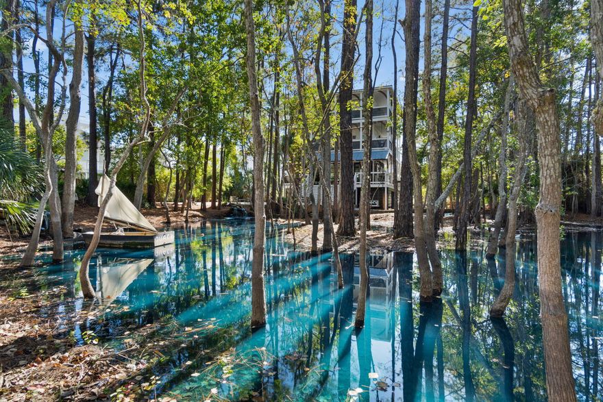 Tucked away in a secluded wooded enclave with a mesmerizing natural aquifer as its centerpiece, this three-story coastal residence stands out with its unique design. The property features a magical aquifer which acts as a magnet for birds and wildlife, adding to the tranquil charm of the setting. Spend serene moments on the sheltered porch amidst the lush foliage or indulge in some evening stargazing or fireside s'mores.This property is second-to-none and would make a peaceful primary residence or memorable second home/vacation rental property with gross rental projections ranging between $90K - $130K. Pristinely maintained, the interior and exterior of this beach home are a seamless extension of the coastal and serene environment, boasting coastal chic decor with shiplap walls,
