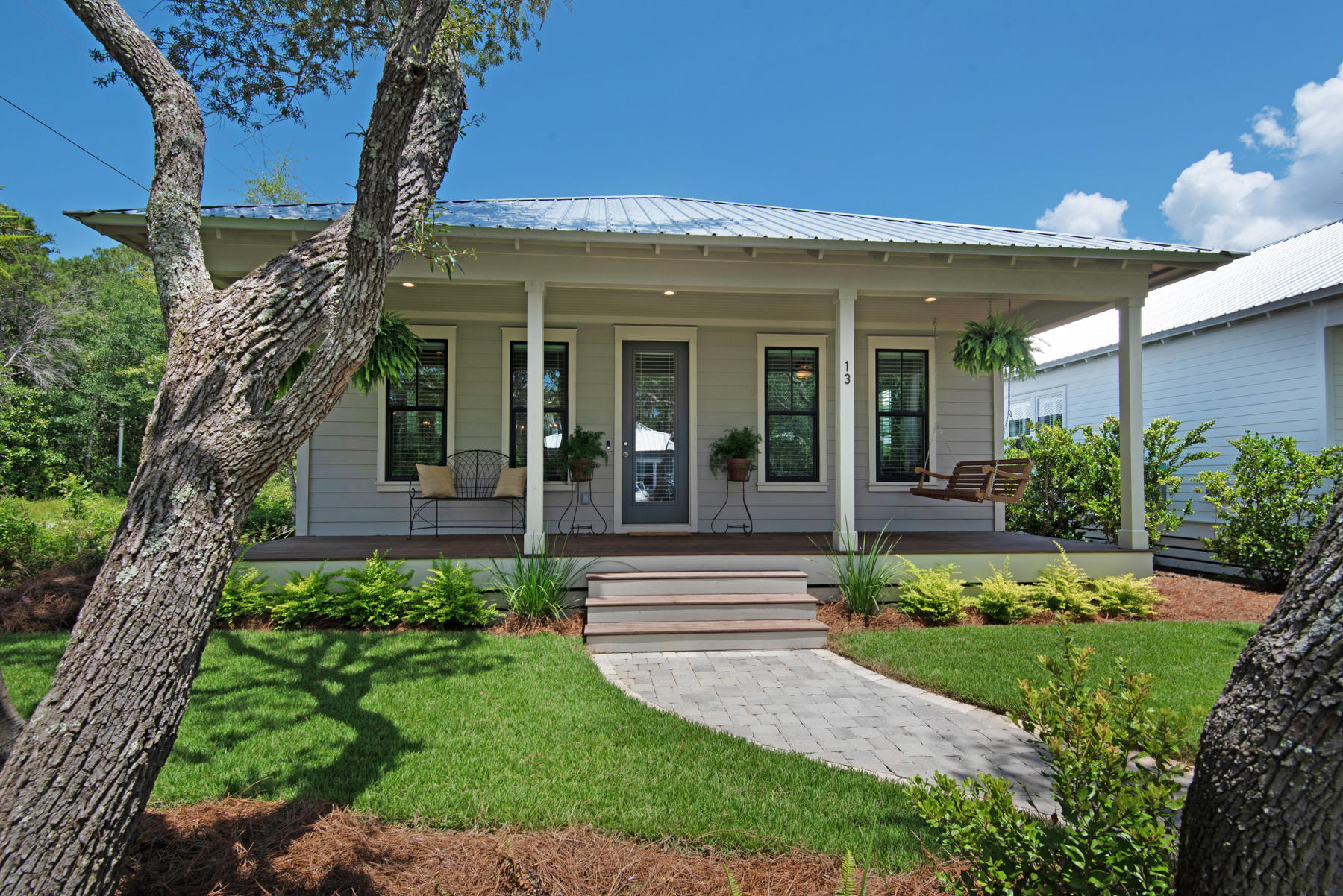 Welcome to Grayton Bayou, a bayside community, just a short ride to the beaches of 30a, located in Point Washington. This immaculate Florida Cottage was built in 2020. The home greets you with a large front porch perfect for a porch swing. A spacious screened back porch is ideal for outdoor lounging and living. The home sits on a corner lot and features an oversized one car garage and a wooden privacy fence. The open floor plan features space for living room, dining room, and kitchen. The kitchen is equipped with stainless appliances, quartz countertops and custom white cabinetry perfect for entertaining. The main bedroom is spacious and located at the rear of the house for maximum privacy. Includes en suite with double sinks and custom tile shower and frameless glass door.