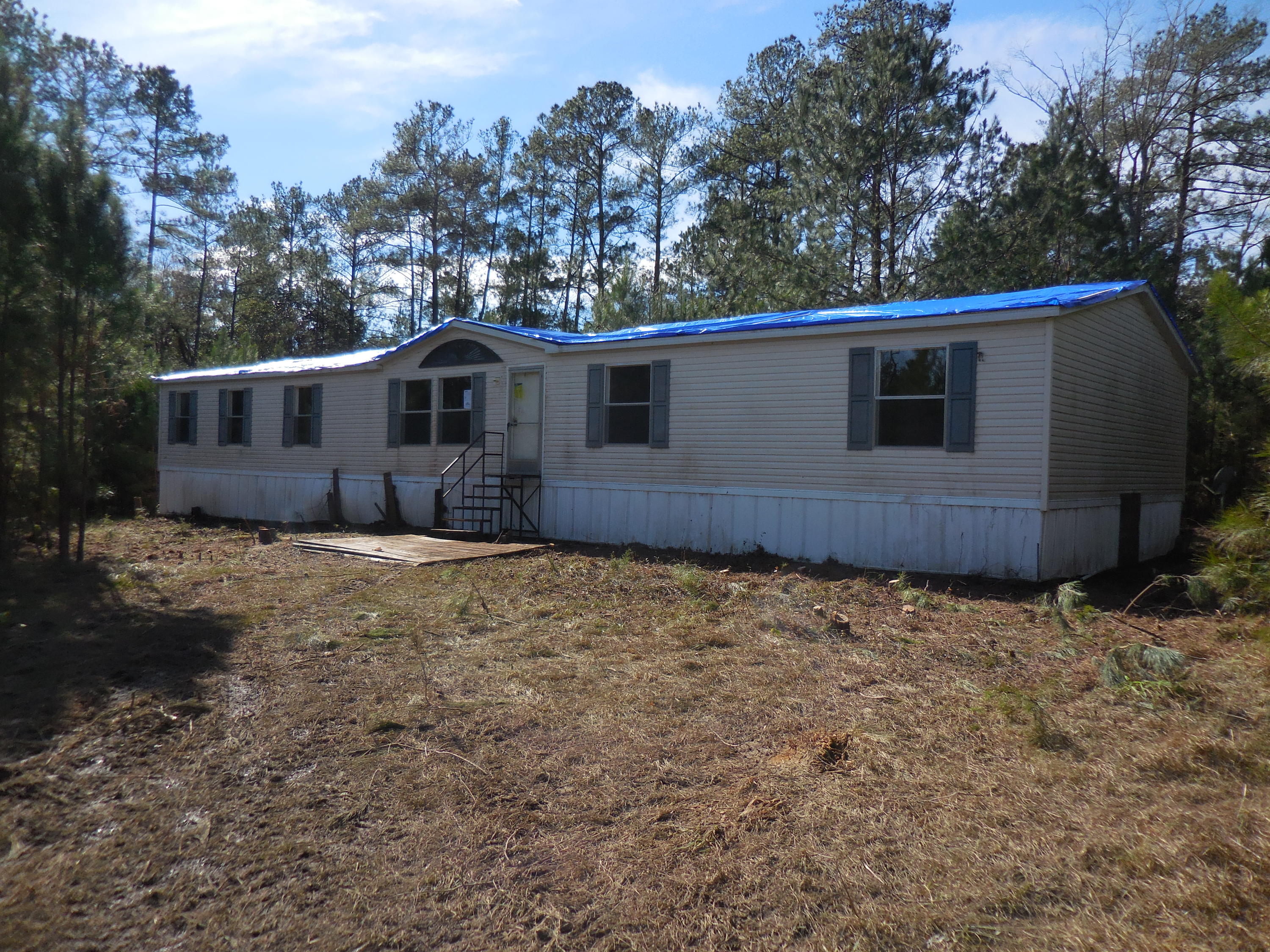WE ARE NOW IN MULTIPLE OFFERS. PLEASE SUBMIT YOUR HIGHEST AND BEST BY 2:30PM CST, MARCH 9, 2016 FOR YOUR OFFER TO BE CONSIDERED.REO. HUNTER'S PARADISE! This 10 Acre parcel just off I-10 and Hwy 331 is teaming with wildlife! The 2052sf, 4 bedroom manufactured home is great for family or for a hunting lodge! There is a living room as well as a family room and the kitchen is spacious and open to a roomy eating area while open to the family room! The master suite features a unique sitting area just before entering the bedroom, and the master bath has both a garden tub, a separate shower, as well as a walk-in closet. The other 3 bedrooms are spacious as well and 2 of them have walk-in closets also. There is a lovely stream which cuts through the property bringing in lots of deer if all the deer
