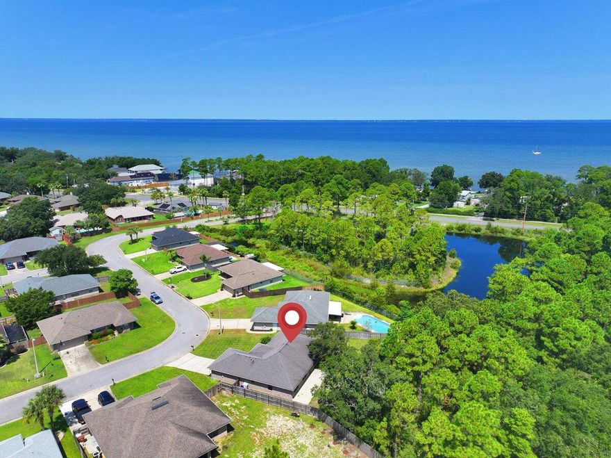 The perfect family home that is move in ready! Welcome to your own piece of paradise in the Bay Pines subdivision of Gulf Breeze, FL. This home has a great floor plan that is spacious, and open. The kitchen has tons of storage and counter space as well as a pantry for extra storage. The master suite has a large garden tub with separate shower. There is a double vanity and walk in closet. The large back yard has a privacy fence and backs up to a wooded area for added privacy.  Shed in the back as well for your outdoor equipment. The neighborhood is centrally located off Hwy 98 and East Bay Blvd., between Pensacola and Ft. Walton Beach. Ten minute drive to beautiful Navarre Beach, with white sandy beaches and emerald blue water.  Five minutes away from the Gulf Breeze Zoo. Fifteen minutes to Pensacola Beach.  Take family bike rides in the evenings, or early morning jogs with your dog down the paved walking path that follows East Bay Blvd.  Just minutes from Woodlawn Beach Boat Ramp, and Soundside Beach as well.  Bay Pines is a quiet and friendly community, and this home is a prime example of coastal living at its very best.  Come and see for yourself!  