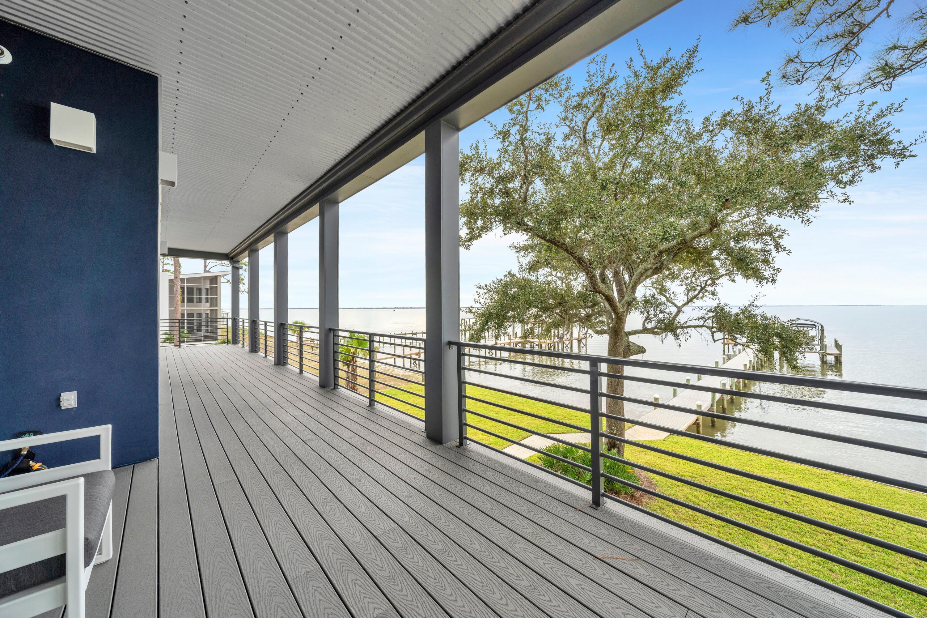 AGE IN PLACE gracefully in this exceptional, accessible luxury home! Healthy Living is yours on the Choctawhatchee Bay! 36 Creek Harbour, a beautifully appointed, one owner, custom built waterfront home. This 2021 build is nestled on a quiet cul de sac in the sought after community of Bay Harbour in Walton County Florida. Thoughtful design meets modern comfort in this healthy home! Serene waterfront living and innovative features are yours! Refresh and reset with wellness in mind, this residence prioritizes air flow, low-maintenance landscaping & inviting outdoor spaces. Enjoy morning yoga or evening relaxation. Enjoy easy-to-maintain custom hardwood flooring throughout and no carpet - ideal for allergy-sensitive residents and offering a sleek, modern style, you will enjoy ADA compliant amenities including a convenient wheelchair accessible elevator. This home ensures comfort for everyone without sacrificing style. Take in sweeping water views from your own private balcony, perfect for savoring sunsets, unwinding with a book, or planting your patio garden! The Boat Dock with swim platform, seating and a lift ensures boating & water enthusiasts will love instant access to endless coastal adventures. Eco-Friendly Features include clean energy systems. A low cost of ownership ensures this home is as efficient as it is elegant. Live in comfort and style with features that support a healthy, active lifestyle and minimize upkeep. Whether you are seeking a peaceful retreat or a place to entertain, 36 Creek Harbour offers a unique blend of luxury, accessibility, and sustainable living, steps from the water. Schedule your private tour and experience the best of Choctawhatchee bayside living!
