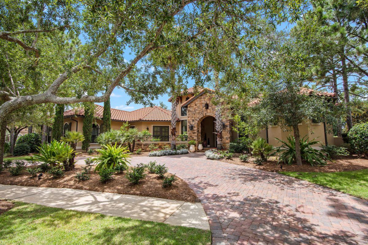 This single-story lakefront home is tucked in the Preserve neighborhood of Burnt Pine, and looks over the fourth hole at the Burnt Pine Golf Course. Built with high-quality ICF concrete for energy efficiency and strength, no detail was overlooked in the construction of this home, and its design features include antiqued travertine floors, custom cabinetry and built-ins, reclaimed wood accents and beams, and 8 ft curved windows that overlook an outdoor oasis. The open-concept living areas are ideal for entertaining, and a spacious chef's kitchen includes granite countertops, high-end appliances, beautiful lighting, and a large bar, as well as a separate breakfast area.This elegant, three-bedroom home includes a luxurious master suite with a sitting area, fireplace, custom-fitted closets