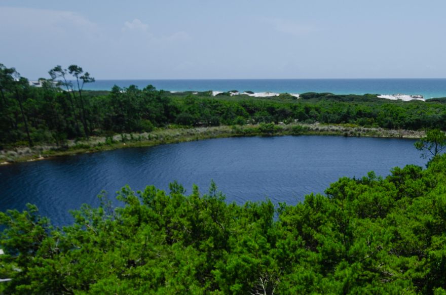 Lakefront Home Site in the Exclusive Gated Community of Redfish - Situated on the coastal dune lake of Little Redfish, the home site offers picturesque views of the protected sand dunes and blue waters of the Gulf. Architectural Design Codes, underground utilities, and attention to preservation of the coastal landscape enhance and protect the value in this exclusive, private 17 lot community. Community dock and beach access. No build out time. Short term rentals are not permitted.A rare opportunity of a unique and private setting in an exclusive enclave - With very few property settings available as such, don't miss your chance for one of the last!