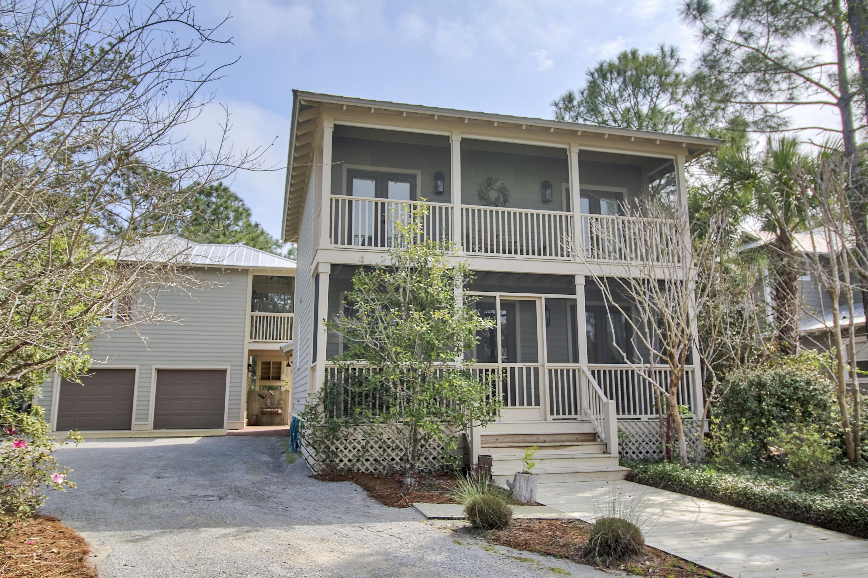 The Grove by the Sea is one of the most quaint and sought after communities along 30-A. This home sits on a large lot and features a three bedroom, two & one-half bathroom main house and a carriage house that is almost 500 square feet with a full kitchen and a separate bedroom and full bathroom. The garage is a real two car garage!!! The back yard is already equip with a large area with pavers perfect for lounging and gathering. Front and back porches are screened in along with a screened in porch on the carriage house. Main house has wood flooring in living room and tile throughout kitchen and dining along with granite countertops. The current owner did many custom upgrades including sinks, doors, etc. This is a must see. Selling fully furnished with a few exclusions.