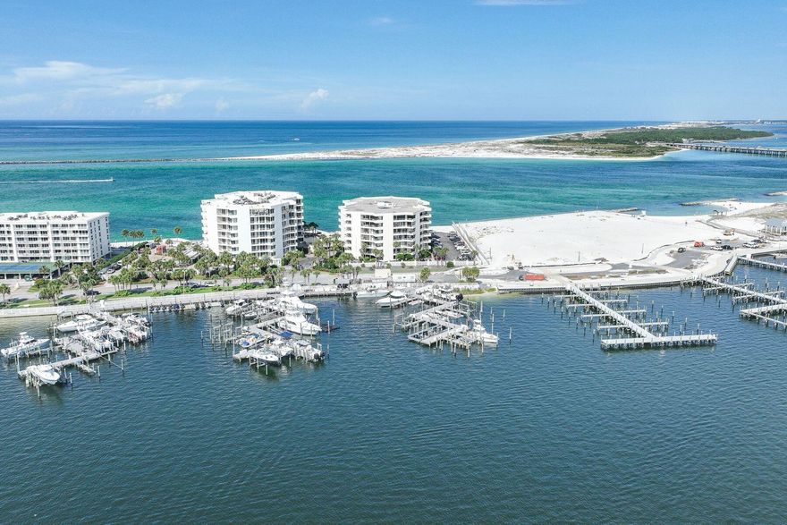 Three Month Minimum Rental Period. Dedicated Garage Parking Spot and Storage. SIRS complete and all assessments paid. Two Master Suites. Beach or boater's delight. Gulf, East Pass and harbor views. Fireworks, air shows and incredible night light views from an expansive balcony. Perched on the sixth floor at the very tip of Holiday Isle, this gracious residence offers panoramic views that sweep from the Destin Harbor to the sparkling gulf waters of the East Pass. Walls of floor-to-ceiling glass and a generous balcony that spans the full width of the unit invite both sunlight and sea breezes into nearly every corner, creating a serene waterfront sanctuary. The spacious layout unfolds with ease, offering a large living and dining area that is seamlessly connected to a well-appointed kitchen, complete with granite countertops, stainless steel appliances, a generous bar, stainless steel appliances, a generous bar, and a dedicated wine bar, all designed for effortless entertaining. Two private master suites, each with its own ensuite bath, provide luxurious accommodations for owners and guests alike, while a third bedroom and full bath offer additional flexibility. Resort-style amenities elevate everyday living, featuring an exclusive owners-only seasonally heated pool, hot tub, fitness center with sauna, a club room for events, as well as a private stretch of white-sand beach. A covered garage space right by the elevator entrance and dedicated storage room add convenience. A private marina just across the street offers deep-water boat slips for sale, for boaters who want to enjoy Destin's famed waterways. No boat, no worries, as you can call the boat taxi to pick you up at the East Pass Marina dock for quick trip across the water to award winning, boat-to-table seafood restaurants and night life on the harbor.  East Pass Towers II is a secure, gated building renowned for its quiet, residential atmosphere with a 3-month minimum rental period. Featuring thoughtful updates, the condo association has proactively nearly completed all needed maintenance and improvements and all assessments have been paid by the seller. From fireworks and air shows on summer nights to tranquil mornings watching boats or dolphins glide by, this is waterfront living at its finest. Destin Executive Airport is just 2.3 miles away for all the pilots wanting to escape the beach or if you prefer charter services. Next to East Pass Towers and nearing completion of improvements is Norriego Point Beach Access and Park where, according to the City of Destin website, will include ADA accessible restrooms, showers, drinking fountains, environmental educational signage, bike racks, boardwalk, dune crossovers, and vehicle parking. 