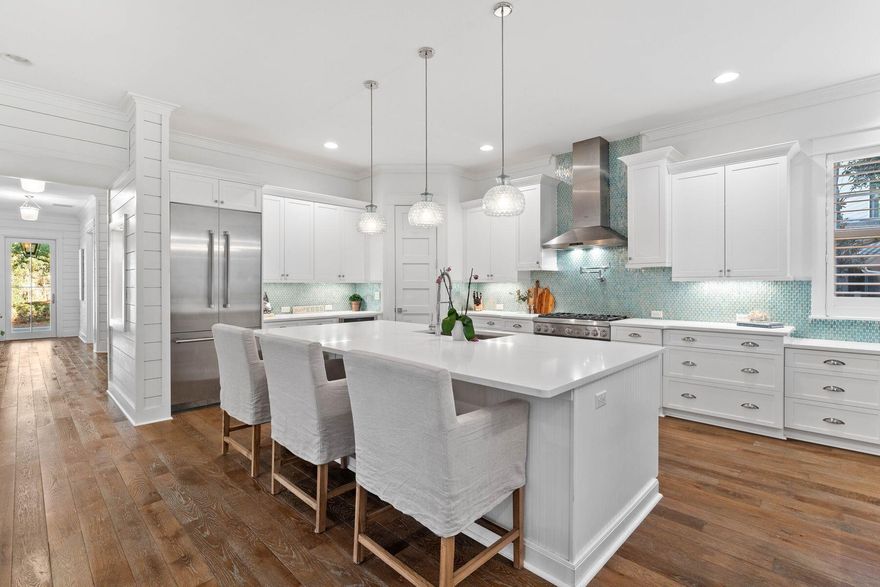 This expansive and remarkable WaterColor home offers ample room for both hosting gatherings and accommodating guests. It includes four beds, 4.5 baths, a bunk room and an office that could be furnished as another bedroom/bunk room. A paved path leads to the open front porch, with lanterns lighting the way to the front door. As you step inside this immaculately maintained home, you'll be greeted by a 25-foot foyer. Stairs and a study with French doors lead off. The hallway brings you into an ample living space with high ceilings, shiplap accents and gleaming hardwood floors. A door opens directly onto a screened porch for relaxing and enjoying the perfect Florida lifestyle. The open floor plan includes a formal dining area for family mealtimes and celebrations beneath the eye-catching light fixture. Oversized windows deliver abundant natural light, accentuating the home's airy ambiance. They frame tranquil views of the lush, wooded landscaping that provides a sense of privacy around the property. The chef's kitchen features premium Thermador appliances, white custom cabinetry and a large center island with quartz countertops. Adding to the fresh coastal ambiance, the gulf-inspired tile backsplash extends to a built-in desk area.The first-floor master suite is a luxurious place to retreat and relax. Shiplap walls and a coffered ceiling elevate this tranquil space. The spa-like master bath has a walk-in shower and dual vanities with contemporary tile from floor to ceiling. Look forward to steamy soaks in the tub after a busy day shopping or at the beach. Head upstairs to an open sitting area to enjoy movies and sports or read quietly. Each bedroom has its own private bathroom, giving guests privacy and space. The home includes a single attached garage for your bikes and golf cart and off-street parking for 2-3 cars. The house is just a hop from the pristine beach for walking and swimming in the shimmering Gulf of Mexico. Community pools and WaterColor Beach Club are a short walk or golf cart ride away. There are plenty of shops and restaurants at nearby WaterColor Crossings, a state-of-the-art fitness center, and a lazy river at Camp WaterColor, which is a true kid's paradise.