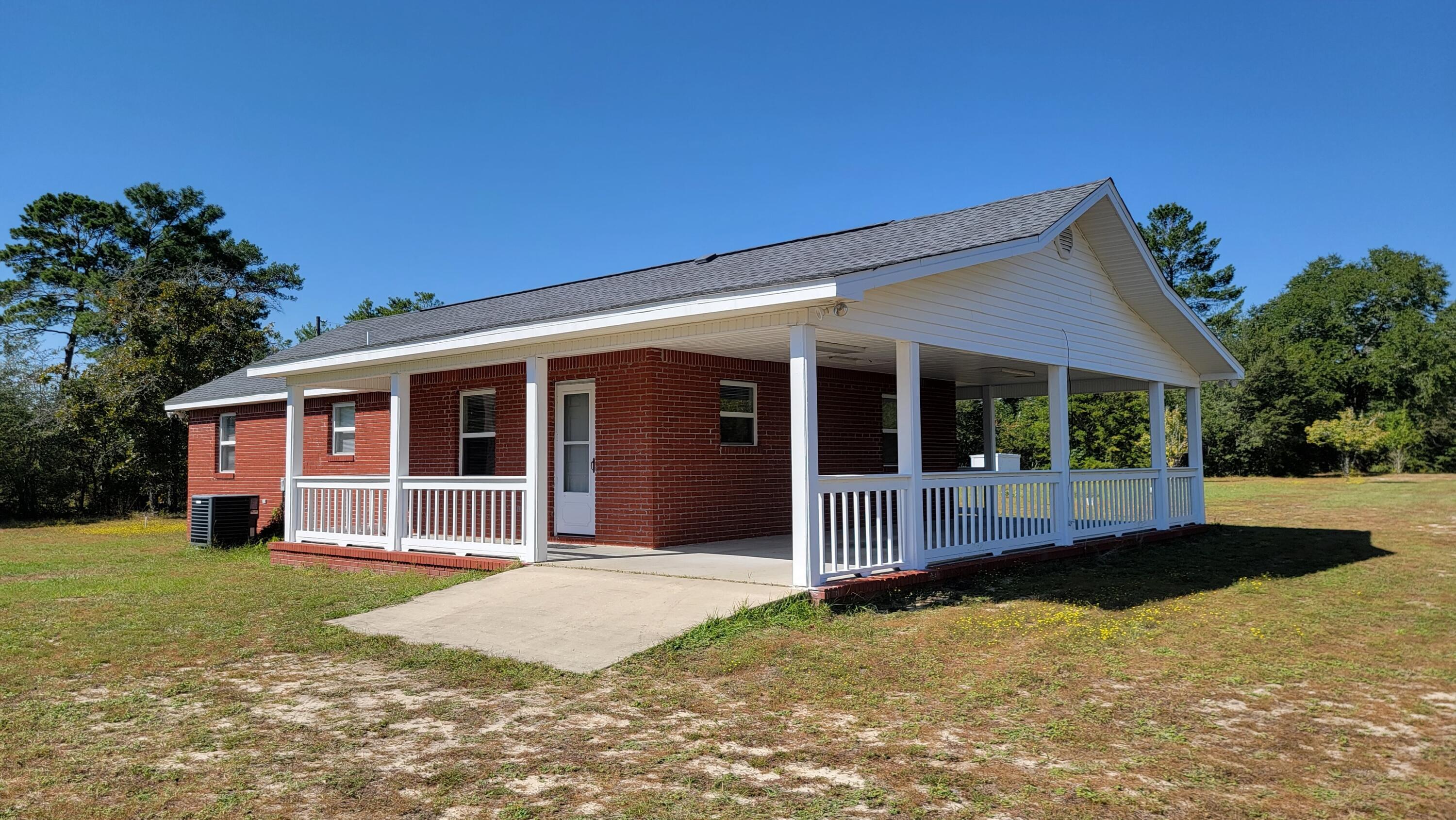 Nestled inside 4.34 acres of wooded land, this house is a nature lover's dream. Located 30 minutes to the beach or 10 minutes to Black Creek boat launch. This updated 2 bed and 1 bath single story home has a new roof, new LVP flooring throughout, new paint inside and outside. There are two carports which can fit three cars or one for a boat. There is plenty of room for parking an RV or large boat. This house has 240 sq ft workspace with electricity, slab new roof and carport. There is also an attached 200 sq ft Shed.