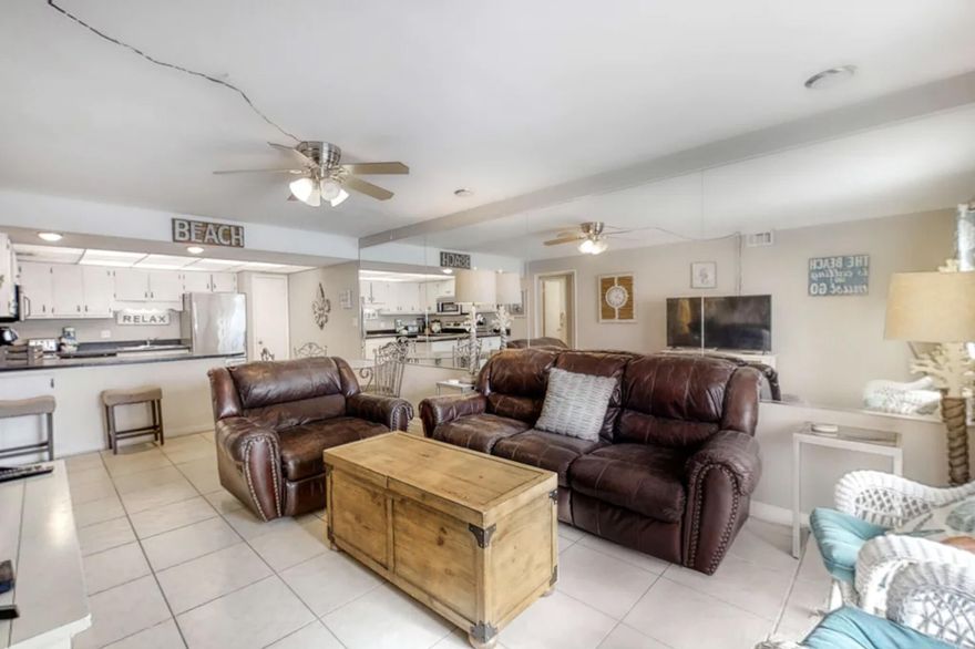 Located directly on the beach on Okaloosa Island w/incredible Gulf-front views, Aqua Villa 405 is the perfect accommodation in Northwest Florida. This 2 bedroom,2bath condo accommodates up to 8 guests, w/a king-size bed in the primary bedroom along w/2 double beds in the guest bedroom. Walking in from the spacious balcony, you will find the living room boasting tile floors, matching furnishings & decor, along w/a flat-screen TV & DVD player. The living area leads to the dining area & kitchen, providing plenty of room to spread out. The glass dining table seats up to 4 guests & there are 2 add'l bar stools by the breakfast bar. Step into the kitchen, offering stainless-steel appliances as well as black counters & white cabinets. Enjoy the relaxing views at the end of the perfect beach day.