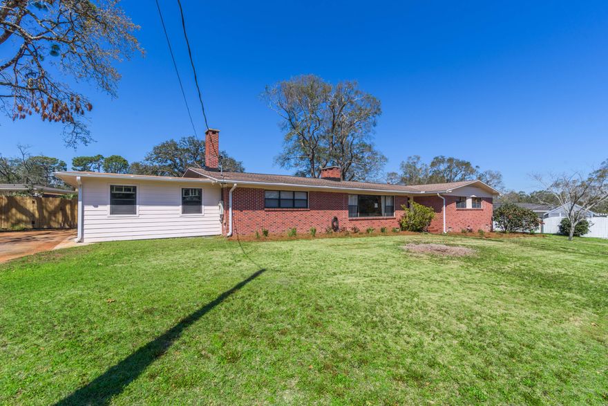 Located in desirable East Hill and bursting with Mid-Century Modern charm, this 5 bedroom home has so many wonderful features to offer. You will appreciate the original hardwood floors, 2 separate living spaces and a bonus room that makes for the perfect In-Law bedroom, play room, gym, home office or the perfect place to run your at-home business. This space would also make a great airbnb opportunity with a separate private entrance. You appreciate the spacious bedrooms and ample closet and storage space and original tiled bathrooms. Upon entering, you'll note the unique original MCM wood burning fireplace that separates the formal entertaining space and dining room. The kitchen is located just off the dining room and comes equipped with newly faced cabinetry, soft close drawers, gas cookt Located in desirable East Hill and bursting with Mid-Century Modern charm, this 5 bedroom home has so many wonderful features to offer. You will appreciate the original hardwood floors, 2 separate living spaces and a bonus room that makes for the perfect In-Law bedroom, play room, gym, home office or the perfect place to run your at-home business. This space would also make a great airbnb opportunity with a separate private entrance. You appreciate the spacious bedrooms and ample closet and storage space and original tiled bathrooms. Upon entering, you'll note the unique original MCM wood burning fireplace that separates the formal entertaining space and dining room. The kitchen is located just off the dining room and comes equipped with newly faced cabinetry, soft close drawers, gas cooktop, new double wall oven, new top-of-the-line garbage disposal and breakfast bar and ample storage. Adjoining the kitchen is the family room/keeping room with wonderful wood built-in bookshelves. The kitchen and family room have new vinyl flooring and all new light fixtures throughout the home. The bonus room has Terazzo floors, a wood burning fireplace, indoor charcoal grill, and climate controlled storage that would make for a great walk-in closet. The garage comes with an additional workshop space (and a 220 line) as well as a yard building for additional storage. Pull your small boat or jet skis behind the extra wide gate right onto the concrete pad. The backyard privacy fence is new and the 10 hens (producing 115 eggs a month) can convey if desired. Other notables are 3 citrus trees, Kwikset Locks on all doors, brick exterior, gutters, gas hot water heater, 3 linen closets, fridge conveys, utility sink in laundry room, new electrical box, galvanized steel plumbing and new landscaping in the front yard. Enjoy walking or riding bikes through East Hill! Just 4 miles to downtown Pensacola and 15 minutes to Pensacola Beach. Check out our full video tour on the MLS and YouTube.