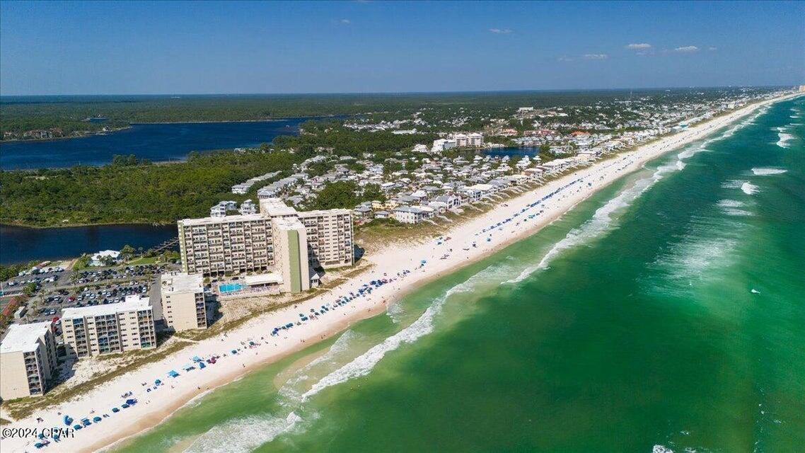 The Sandy Feet Retreat is an updated move-in/ rental ready beach getaway that epitomizes sophistication and convenience for all guests! This property features two elegantly appointed bedrooms and two and a half baths, accommodating up to 8 guests in a serene setting with captivating views of the lake and the beach. Small vessels, kayaks, and paddle boards access is made convenient with a boat launch and slips. Two pools, one with its indoor and outdoor accessibility, ensures year round enjoyment. Recreational facilities such as tennis courts, pickle ball, shuffleboard, bocce ball, and a playground are complemented by the on-site Starfish Grill, offering poolside and beachfront dining.The property is pet friendly for owners, adding to its appeal for those traveling with animal companions. The Sunset room provides and exclusive event space while separate men's/women's saunas and a library offer relaxation opportunities, making the Sandy Feet Retreat a premier choice for a professional luxurious retreat. HVAC (2018) All Appliances (2018).
