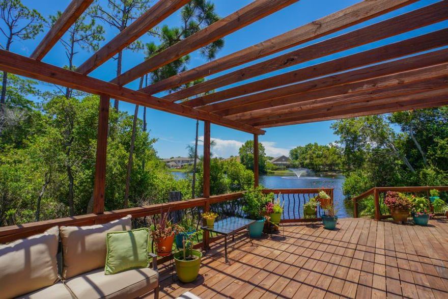 A MUST SEE!  This Custom built one-story Lake Front home has been completely renovated and is tucked away in a cul-de-sac in Destin's gated community of Emerald Lakes.  It has 3 bedrooms, 2 1/2 bathrooms plus a separate office area.  It comes with high-end finishes such as wood-look porcelain tile throughout and quartz countertops in the kitchen and bathrooms.  The living room has built-in book cases, a fireplace, cam lighting, crown molding and access to the deck with awesome views of the lake.  The Master bedroom has an ensuite bathroom with two vanities, custom shower, freestanding bathtub and access to the deck for your morning coffee.  The large wooden deck in the back yard is partially covered with a pergola and overlooks the lake.  The 2 car garage is oversized and the driveway