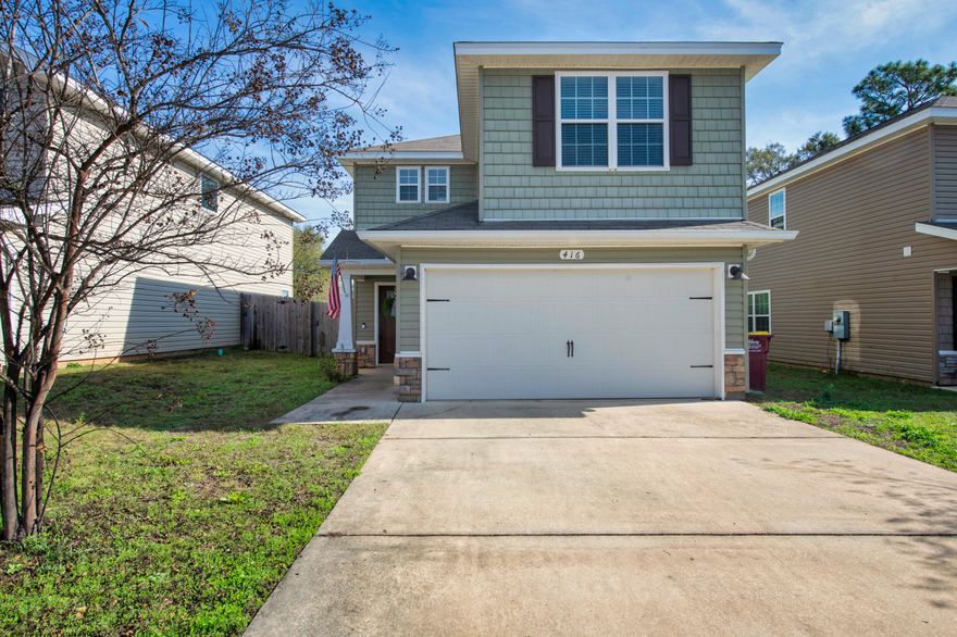 This charming home offers an open, airy layout, designed for comfortable everyday living. Downstairs, the spacious living area flows seamlessly into the kitchen, which features a breakfast bar, pantry, and direct access to the dining space. From there, step out to the fenced in backyard and patio, perfect for relaxing or entertaining. A convenient half bath on the main level makes hosting easy.Upstairs, you'll find three generously sized bedrooms, a full bathroom, and a large utility room. The primary suite includes a roomy walk-in closet and a private bath with a garden tub and separate shower. Outside, the home is accented with stone details, vinyl siding, decorative columns, a fully landscaped yard, and a two-car garage; adding great curb appeal to match the inviting interior. Assumable VA Loan available at 4% interest rate if under contract within 2 weeks of listing at full asking (VA qualified buyers only at this time). 