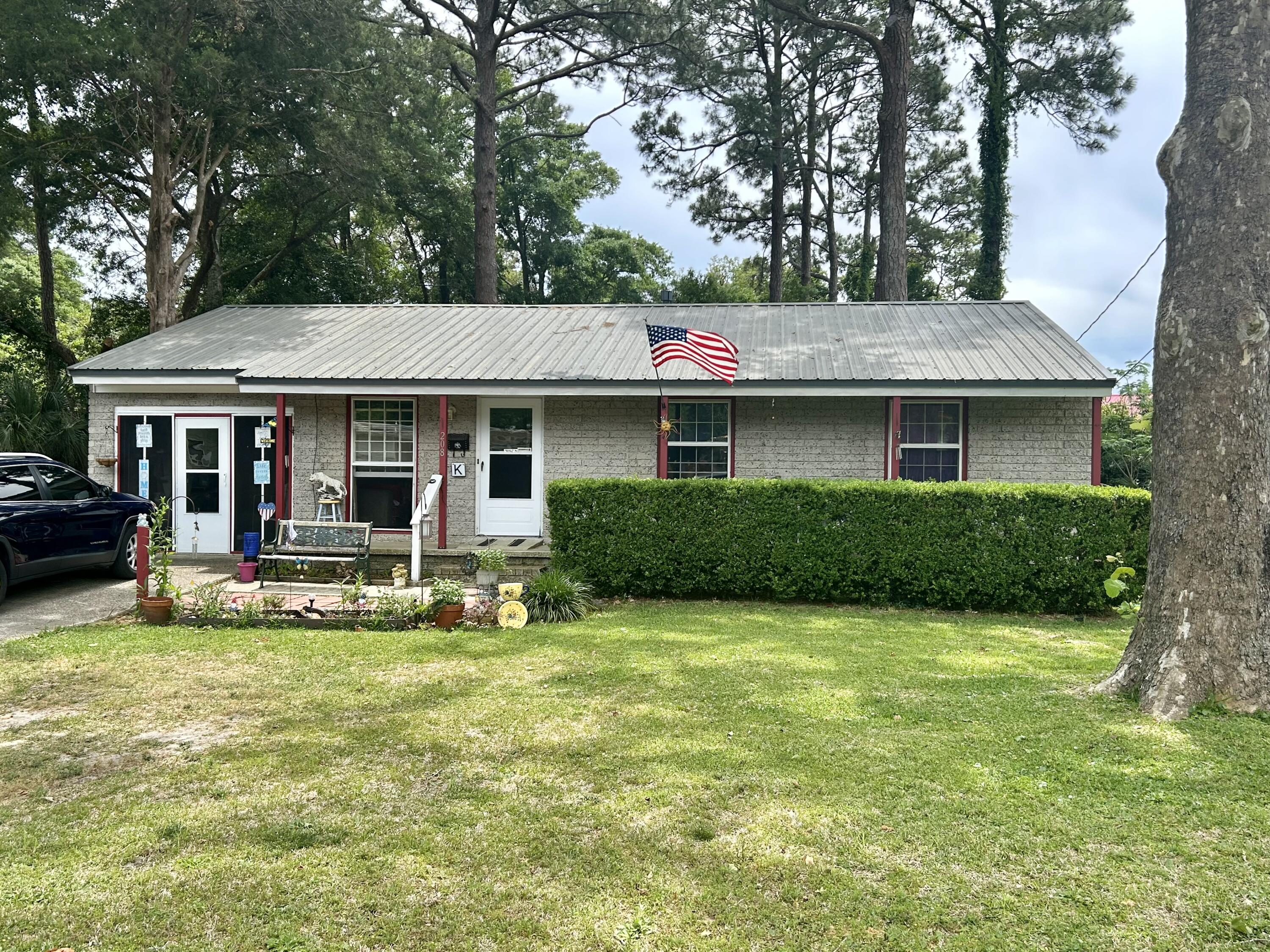 Photos coming soon! Welcome to FWB! This home sits less than one mile to water access and beaches at Choctawhatchee Bay and less than two miles to the beautiful Emerald Coast white sand beaches and all Okaloosa Island has to offer!This 3 bedroom 1 bathroom home sits on one of the larger lots in the neighborhood at .35 acres. Be impressed by the curb appeal featuring large mature trees, colorful landscaping and metal roof. Enjoy your evenings in the one car garage that has been partially converted to additional living space with screen door entry, backyard access, storage cabinets, window AC and more. Inside you will find original hardwood floors and 3 bedrooms. The kitchen has newer appliances and LVP flooring. The washer and dryer and additional refrigerator in garage will convey