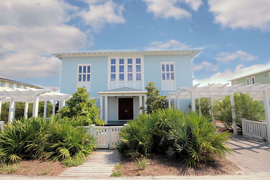 A double set of custom made mahogany doors greet you as you enter this beach side cottage. Beautiful red oak floors throughout and the extensive use of granite, marble and tile in the kitchen and baths are a taste of the details that await you. Each of the three bedrooms has its own private bath. The second level is where you will find the gorgeous granite kitchen with glass-door cabinets, Sub-Zero refrigerator and gas Thermador cook top. The abundant use of floor to ceiling windows, combined with high ceilings, create a bright, sunlit and open feeling in this home. A beautifully designed staircase leads you to a third level bridge (with built-in shelves), overlooking the living area, and opening to a sun deck that provides breathtaking Gulf views and an excellent spot to watch the