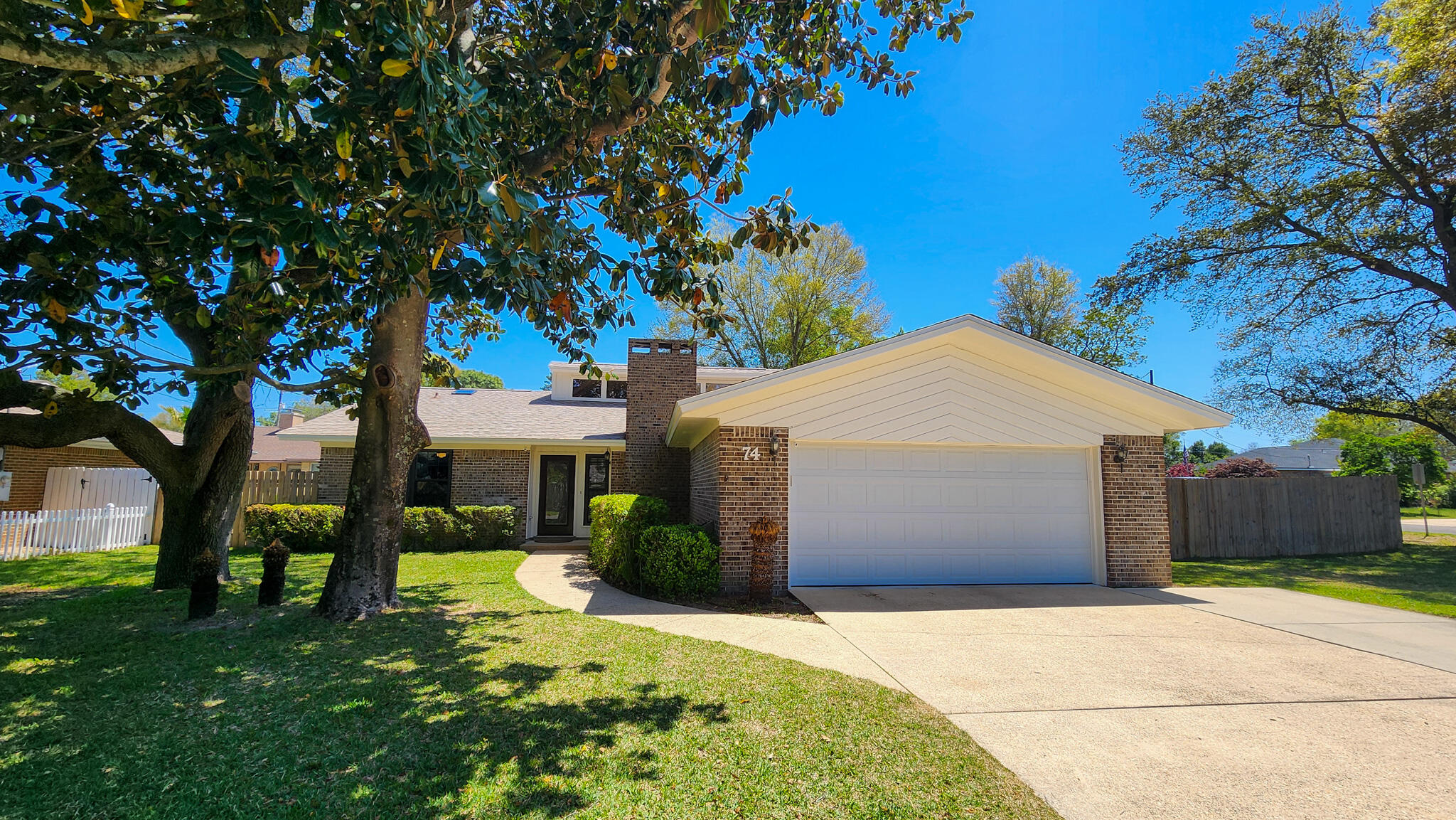 Welcome Your Family and Friends! Beautifully well maintained brick home situated on a large corner lot. - Step inside and you will be delightfully surprised by the spacious living area with high ceilings and plenty of natural light from the windows above. Dining area is open to the living area making entertaining a breeze. Kitchen has lots of counter space and a large breakfast bar, also windows over the sink overlooking the backyard, Sliding glass doors lead out to your large screened-in Florida room for year round enjoyment. Split bedroom floor plan allows everyone additional privacy. Master bedroom has a private master bath with tile. Two bedrooms and a full bath complete this well designed home. New roof 2025, HVAC system and Water Heater 2021. Plus additional parking!