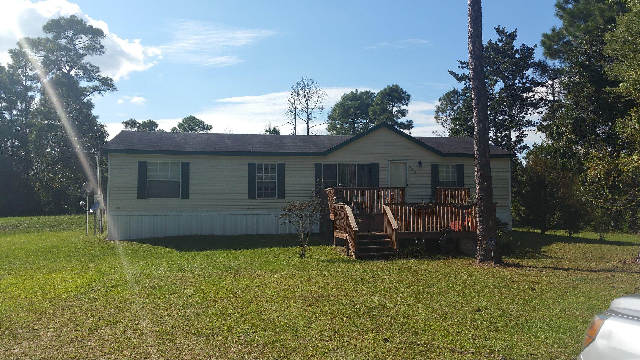 2 Acres and a VERY MOTIVATED Seller!!! for this Beautiful well maintained double wide mobile home built in 2005. This home sits on a well cared for piece of land 1 acre is cleared and 1 acre is wooded. Property has well built chicken coop and established garden, This home offers an open floor plan with split bedrooms, work shop fit for a king with large covered car port and second floor loft with electricity. The view of the adjoining property is amazing with a fully stocked fish pond that is tranquil and inviting. Seller says bring all offers!