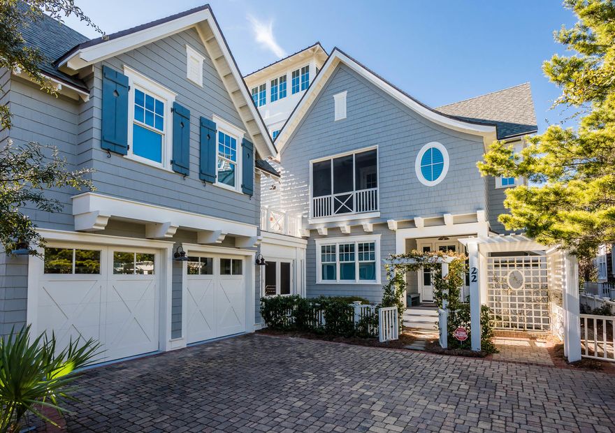 Distinguished by its wood cladding, blue Board and Batten shutters, and welcoming verandas, this classic yet informal beach retreat combines contemporary architectural influences with historic New England born aesthetic. Wooden pathways transport you through the picturesque community nestled among the rolling dunes of WaterSound Beach. The home's arbor adorned with flowering vines welcomes you to this 4,257 square foot estate which features a fun and functional reverse floor plan. The spacious 4 bedroom main house with a bonus bunk room offers an appointed carriage house and can be found in the heart of the private community. Soaring ceilings, wood floors and natural light abound, this home donned in ornate wainscoting and simple shiplap paneling creates a coveted and