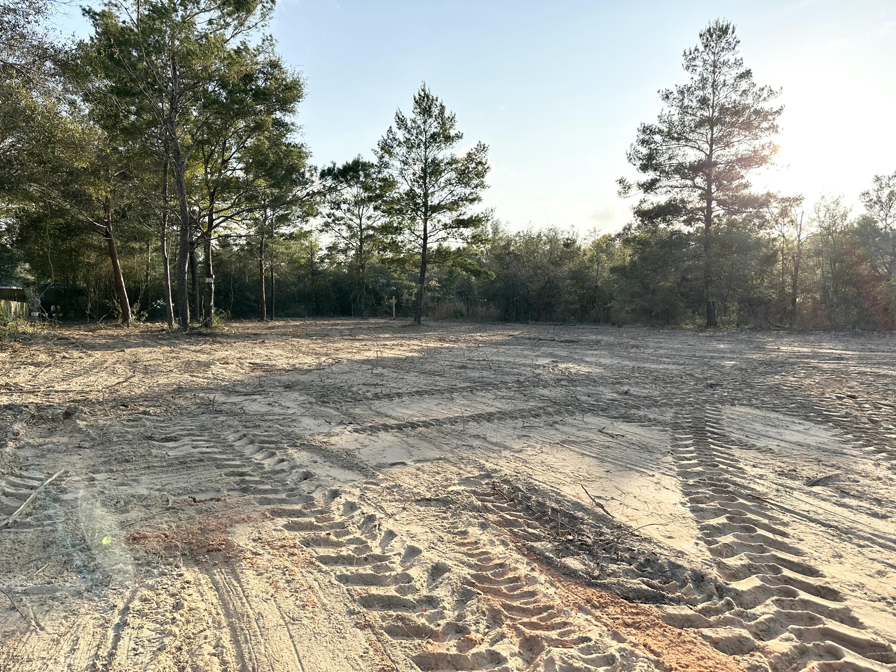 LEVEL, CLEARED, & SURVEYED.... Saving the new buyer time & money. Manufactured homes are allowed in this unit of OAKWOOD HILLS (Unit 1). It is located on a county maintained dirt road, not far from a paved road, & has access to public water. There are no utilities currently present on this lot but water & power are readily available. You will however need a septic system.