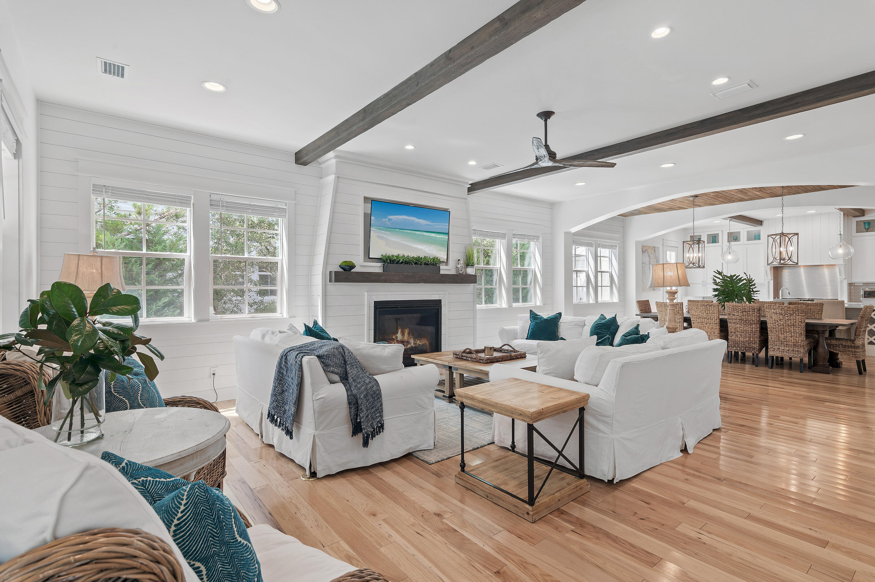 This custom-built five-bedroom home in Seacrest Beach seamlessly combines luxury and space. Features like high wood ceilings, hardwood hickory floors, shiplap walls, and a cozy family room fireplace add character. The gourmet kitchen is equipped with Quartz countertops, Thermador appliances, and a six-burner gas range with two ovens, making it ideal for chefs. The first-floor master suite functions as a family room with a king bed, built-in bunks, and an ensuite bathroom, while the second-floor master offers a private suite with double doors opening to a sitting area with a gas fireplace, a separate bunk room, a large walk-in closet, and a private balcony. The luxurious ensuite includes double vanities, a soaking tub, and a walk-in shower for a spa-like feel. The second floor also hosts a laundry room and three bedrooms, each with its own bathroom. The third floor features a spacious den and game room with built-in bunks, a half bath, and a wet bar with a mini refrigerator. Large balcony and covered porch areas provide peaceful retreats. Conveniently located between Alys and Rosemary Beaches, this expansive home sleeps 18 and offers strong rental potential. Seacrest Beach is pet-friendly and boasts amenities such as a 12,000 sq. ft. lagoon pool with a cafe and terrace. Use the community tram to access the deeded beach access for stunning Gulf waters and white sandy beaches. Nearby hiking and biking trails connect neighboring areas, offering easy access to dining, shopping, and relaxation spots.