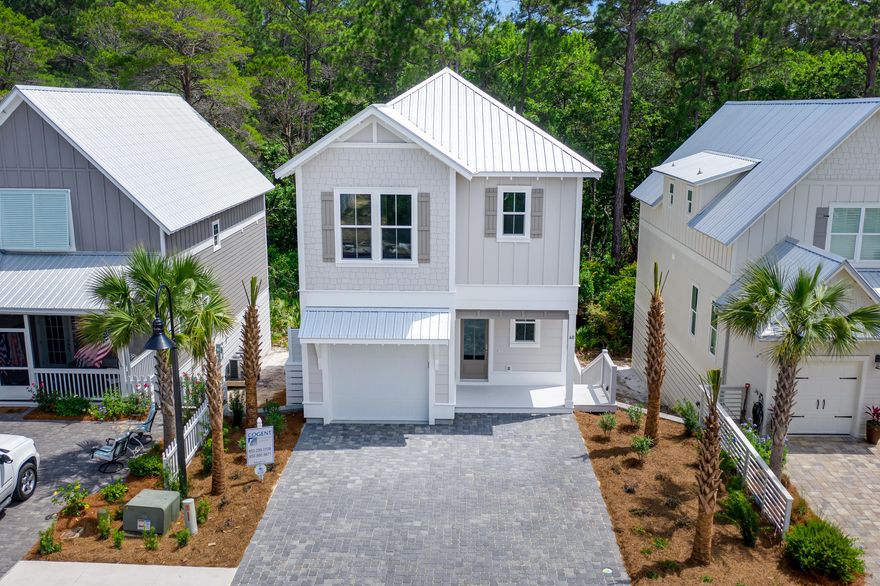 HOME IS CURRENTLY UNDER CONTRACT BUT ACCEPTING BACK UP OFFERS. Quality custom built home walking distance to the beach- half a mile! Hard to find brand NEW beach house in the $500s with 1 car garage for all your beach toys! Two master suites- perfect for 2 families. This reverse floor plan home is built for you to enjoy the wooded views behind the home from the 2nd floor living/ kitchen area. 1st floor features bunk room suite with 2 sets of bunks- one queen & one double and it's own private bath with the most fun tile on the floor. Also finishing out first floor is a master suite and laundry room. Perfect for dropping the beach towels and not tracking sand through the house.