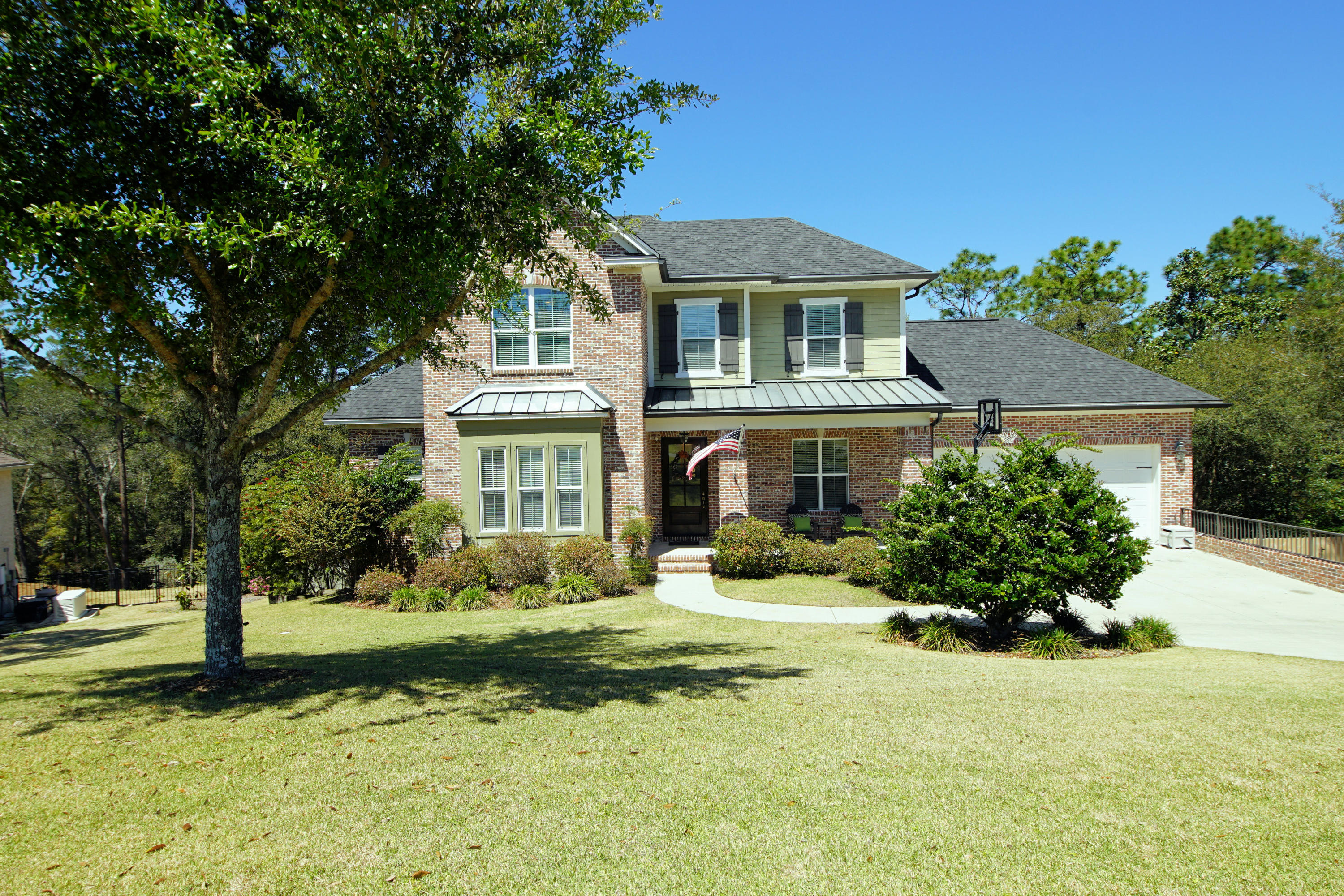 BETTER THAN NEW home in Swift Creek Plantation with a sparkling pool built by award winning Randy Wise Homes, renowned for both the quality and design of their ''walk-out basement'' homes! This gorgeous brick home is located on a half-acre lot that borders a greenbelt so the large back yard is very peaceful and quiet. A friendly front porch welcomes you into this beautiful home. Upon entering the home, you will immediately notice the warm wood floors, high 10' ceilings accented with crown molding and an abundance of light coming through the large windows along the back of the house. There is a cozy office to the left of the foyer and down a short hallway, you will find the open kitchen, dining and living area. The kitchen is a chefs dream with an abundance of gleaming walnut cabinetry,