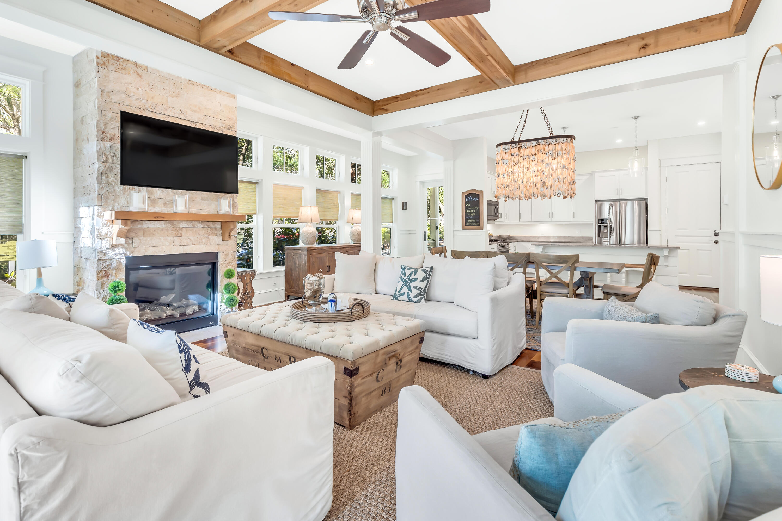 Nestled within the prestigious Cottages at Eastern Lake community in Seagrove Beach, this exquisite custom-built family retreat epitomizes coastal luxury living just south of 30A.  Step onto the welcoming front porch and immerse yourself in the airy ambiance of the open-concept kitchen and living area.  Bathed in natural light, the living space showcases stunning wooden beams adorning the ceiling and elegant wainscoting gracing the walls.  A striking natural stone fireplace serves as the focal point, complemented by a large screen TV mounted above it.Maple wood floors grace the main level flowing seamlessly throughout the residence.  The sleek and modern kitchen boasts white cabinets, quartz countertops, and stainless-steel appliances, including a gas stove and French-door refrigerator. Conveniently located off the living area on the lower level are a powder room and a laundry room.
This remarkable beach house boasts dual master bedrooms, each with its own ensuite bathroom.  The first master, situated downstairs, offers a king bed and access to a serene back porch concealed behind floor-to-ceiling curtains.  The ensuite features a double-stone vanity, a tiled walk-in shower, and abundant natural light.  Upstairs, the second master bedroom features expansive windows framing the king bed headboard, while the ceiling is adorned with exquisite cypress wood, echoing the maple wood floors below.  Its ensuite bathroom showcases a double-stone vanity, walk-in shower with built-in seating, and a spacious walk-in closet.
Also located on the second floor is a charming guest bedroom with a queen bed and shiplap accented walls.  Its ensuite boasts a double-stone vanity and tiled walk-in shower with glass doors.  Additionally, the second floor hosts a delightful bunk room with two sets of twin-over-full bunk beds, accommodating up to six guests.
The Cottages at Eastern Lake community offers resort-style amenities, including a palm tree-lined pool and access to Eastern Lake for kayaking, canoeing, or paddleboarding.  Also, owners and guests will enjoy quick access to the Gulf, with a short bike ride from your doorsteps to 3 public beach accesses and Deer Lake Park.  A boat ramp on Eastern Lake for your kayaks and paddle boards is a 2 minute walk.  Also within easy walking distance, on the north side of 30A are restaurants, coffee shops, an ice cream shop, fresh seafood market, beach sundries and various other boutiques.  Lastly, the Cottages at Eastern Lake are located just minutes from Seaside, Alys Beach, and Rosemary Beach truly providing an unparalleled coastal lifestyle experience.
The home conveys fully furnished with the exception of a few personal items and property management company linens.  Seller has already moved to his next property and says no reasonable offer will be refused.  Call or contact your agent to arrange a private showing.
