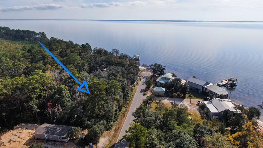 Price adjustment! Almost 1/2 acre lot just steps to the bay! Opportunity to purchase the adjoining lot (MLS 887178) for almost an acre! Zoning is rural village with land use as rural residential. Level lot, backs up to Eglin AFB property, ready for your new home or venture. According to flood maps, only a small portion towards the front is zoned AE with roughly 90% in flood zone X . Please see recent wetlands survey for details.