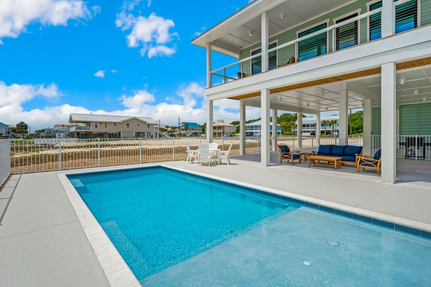 New construction home perfectly placed on the 2nd Tier on St. George Island, this custom-designed single-level home is beach living at its finest. Suited for your family & friends, with all the amenities one could ask for. Every inch of this remarkable beach home is finished to the highest standards with ceramic-tiled bathrooms, quartz counters, stainless-steel appliances, high-end finishes, and luxury vinyl plank flooring throughout. This exceptional beach home with its two magnificent Gulf view master suites, two additional king suites, and a bunk room. The ground level is for fun & relaxation with a private heated pool & hot tub. With an RV/EV charging outlet, RV and boat parking available, this home caters to all your needs. Clean your catch at the convenient fish cleaning station, and
