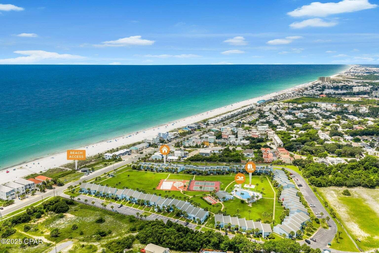Welcome to Sunnyside Beach & Tennis Resort Unit #6 -- a beautifully renovated 2-bedroom condo with a spacious loft and 2.5 baths, offered furnished and turnkey! This thoughtfully redesigned home underwent a full remodel beginning in 2018, maximizing both functionality and comfort for full-time living, a luxurious beach getaway, or savvy vacation rental. Inside, you'll find beautiful wood shiplap ceilings throughout, adding to the coastal charm of this unit. The HVAC system was upgraded to improve airflow, including added vents in the upstairs bathrooms and master bedroom. The custom kitchen was designed for entertaining, featuring ceiling-height solid wood cabinetry, Cambria natural quartz countertops, a large island with sink and dual-end access, and high-end Samsung Wi-Fi capable appliances, including a built-in undercounter ice maker and a beverage fridge. The adjacent dining area boasts a custom driftwood light fixture, and the nearby laundry room includes additional cabinetry and a small deep freezer. The living room offers a cozy electric fireplace built into the TV console, while the downstairs half bath includes a new vanity and linen closet. Every inch of space has been optimized with smart storage solutions, including a large walk-in pantry with custom shelving, a full-size storage closet above the stairwell, a full-size door under-stair storage area, and a pull-down attic staircase. Tile flooring runs throughout the lower level and bathrooms, with oak stair treads stained to resemble driftwood. Upstairs, the balcony showcases custom iron spindles with stained glass inserts designed to mimic ocean waves. Outside, both the front and back areas have been professionally landscaped, and the sale includes all exterior furnishings, fire pit, grills, and storage boxes. The Sunnyside community is very much a family-oriented environment, with interior sidewalks and large green space where children can safely ride bikes and play. The HOA also offers convenient boat and trailer storage for just $100 per month. Sunnyside Beach & Tennis Resort is a highly unique and sought-after community, consisting of only 74 townhome-style residences spread across 20 beautifully maintained acres with 264 feet of deeded beachfront. Additionally, it's the only property in Bay County that features a private tunnel under Front Beach Road, offering safe and direct access to the beach. This rare gem blends coastal charm, modern comfort, and a true sense of community in one of Panama City Beach's most exceptional resort settings.