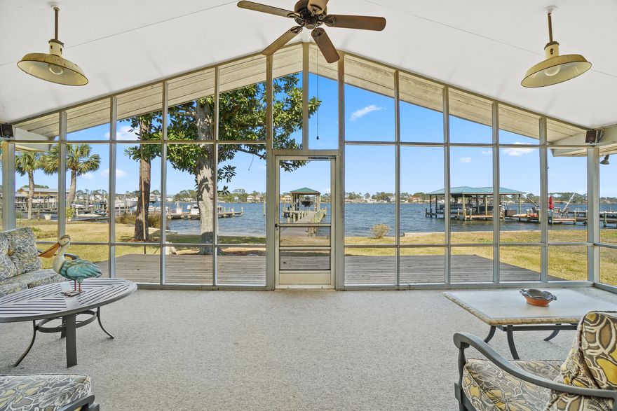 A boater's paradise awaits in this unique two-in-one investment opportunity on South Lagoon Drive in Panama City Beach. Enjoy deep water access to St. Andrews By, Shell Island and the Gulf of Mexico with 75 feet of water frontage just moments from the bridge. A brand new electric- and water-enhanced dock with 8,000-lb. boat lift, covered boat house and fish cleaning station enhance its appeal. The structure of this purchasing opportunity includes two lots, one with a three-bed, two-bath home and an adjoining vacant lot, both adding to .27 acres. This allows for numerous possibilities including short-term rentals through platforms like Airbnb; building an additional home on the extra lot; adding on to the existing home; or, demolishing the existing home to build a larger residence
