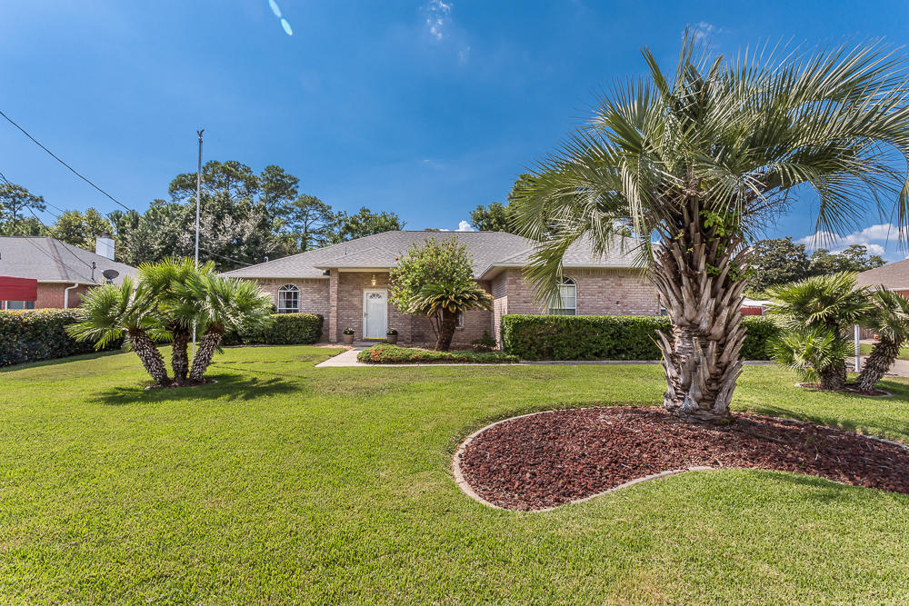 Located in the sought-after Villa Venyce subdivision, this beautiful all brick home is adorned with professional landscaping, a sodded lawn and irrigation system, and a concrete sidewalk and driveway. The entry way opens up into the large great room with a high, arched ceiling, fireplace and beautiful hardwood floors. There is even a separate dining area and breakfast nook overlooking the 15 x 15 sunroom. The kitchen is very spacious and features tiled flooring, quartz counter tops, numerous cabinets and stainless steel appliances. This leads to the laundry room and spacious two car garage. With a convenient split floor plan design, there are two good sized guest bedrooms with large closets and a spacious guest bath. On the other side of the home is ....