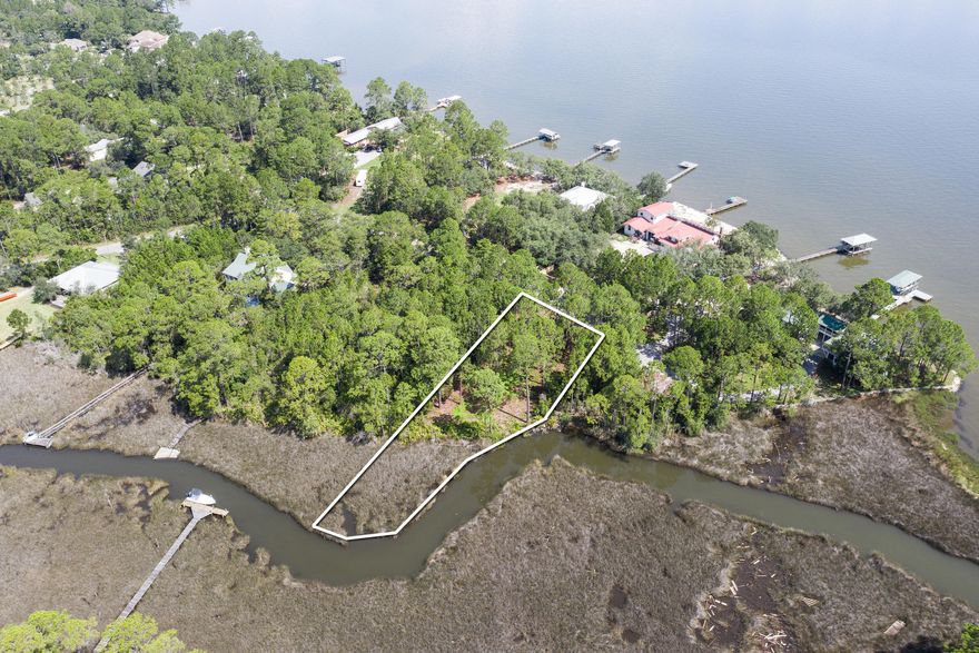 Beautiful Bayview lot located in the quiet Bay Pines community in Santa Rosa Beach. This property is a great location for building your custom home providing unobstructed bay views and over 200 ft of water frontage. This is the perfect location for anyone seeing privacy with lush landscape and county park land adjacent that can never be built on. Paddle or boat right from your property to the Choctawhatchee Bay! Call your agent for more details including a completed wetland delineation, survey, sellers disclosure, and setback requirements.