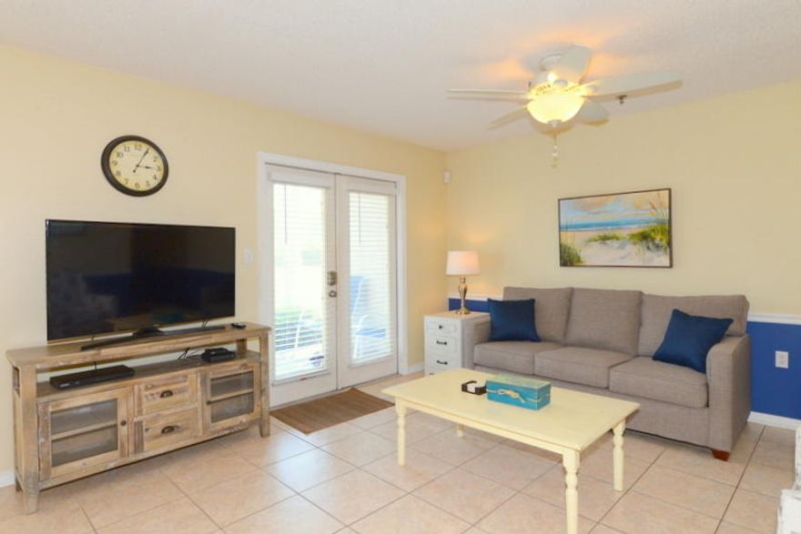GREAT BEACH GETAWAY! This two bedroom, two bath unit is well-furnished & accessorized. It is located just across the street from the beach access. The master bedroom houses a king-size bed while the second bedroom has a full-size bed plus bunks with double bed & twin plus there is a sleeper sofa allowing nine to sleep comfortably. Floors are tile & wood. All furniture is nice (living room sofa & chair are brand new). The kitchen which opens to the living area has brand new stainless steel appliances, a nice pantry, breakfast bar, & pendant lights. Double French doors open from the living area to a pretty patio to relax on while enjoying the gulf breeze. Grand Caribbean East is a great complex in the heart of Crystal Beach. It has a heated pool, grills, & picnic area. Enjoy a short