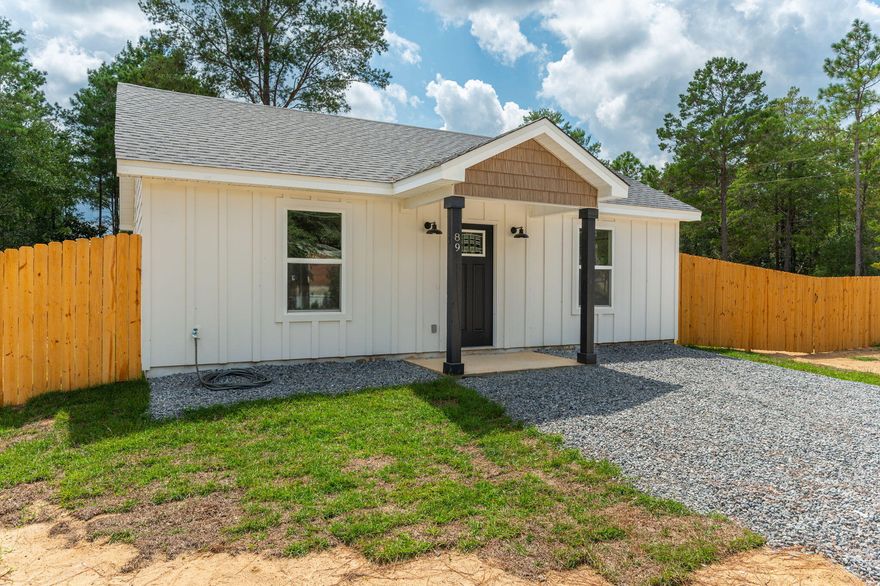 This brand new adorable 800 sq. ft. cottage is serving up charm on nearly a quarter-acre lot. Nestled on a county-maintained road, the curb appeal is on point with fresh sod landscaping, a covered front entry, and a breezy back patio perfect for morning coffee or sunset unwinding. Need parking? No problem. The gravel pad has you covered. Wrapped in classic board & batten, hardie board siding and topped with a shingle roof, this beauty was built to last. Step inside to an open living space with soaring ceilings, giving you that airy, spacious feel. Luxury vinyl plank flooring runs throughout, because style and durability should go hand in hand. The shaker-style cabinets, granite countertops, and stainless steel appliances make the kitchen both sleek and functional. Two cozy bedrooms are tucked on either side of a full bath, featuring a granite countertop vanity and a tub-shower combobecause who doesn't love a relaxing soak after a long day? And with ceiling fans in every room, you'll stay cool while looking cool. Plus, public water means no well maintenance headaches.
This charming retreat is big on character, smart on design, and ready for you to call it home! Don't waitsnag this gem before someone else does.
