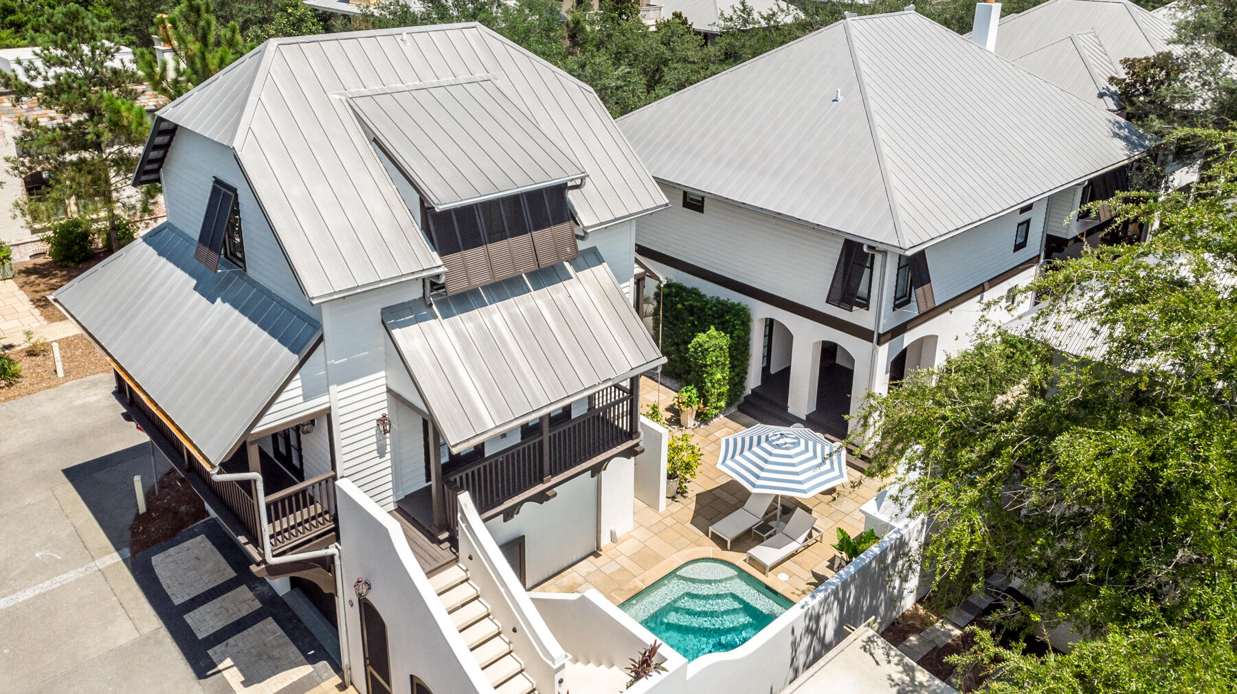 This spectacular contemporary residence is perfectly situated on a coveted oversized corner lot in beautiful Rosemary Beach. High-quality construction is apparent upon entering an inspiring great room with two-story soaring ceilings, a feature fireplace, and a winding staircase. Designer lighting fixtures can be found throughout this 3,322 sq ft home. A gourmet kitchen features all new appliances, a Scotsman pellet ice machine, Cambria quartz countertops, and wood shaker cabinets with soft close doors and drawers. Double doors lead out to an exquisite private outdoor courtyard with beautiful landscaping, a large saltwater pool with all new pool equipment, outdoor fireplace, summer kitchen and water fountain and three outdoor living spaces....