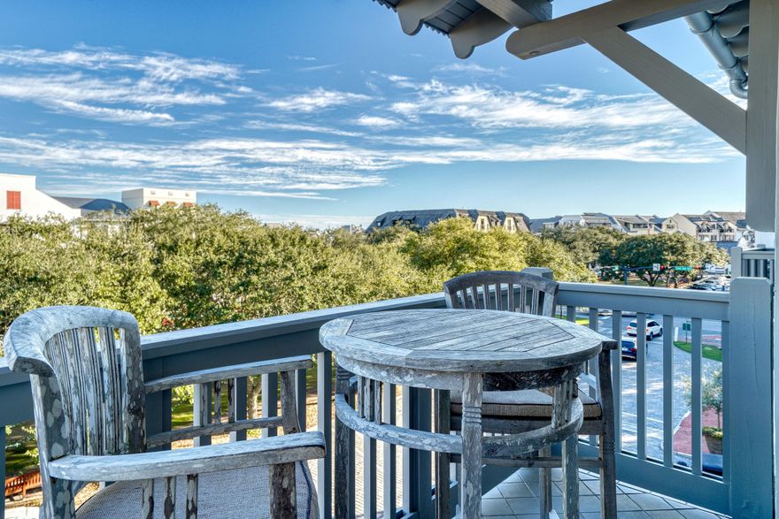 Situated in the desirable Lofts West complex, with views across the Rosemary Beach town center, this penthouse residence encompasses over 1,200 square feet of thoughtfully designed and freshly updated living space. Upon entry you are greeted by the spacious living area featuring soaring 20' vaulted ceilings and stunning hardwood floors. The Chef's kitchen encompasses a luxury appliance suite, glass mosaic backsplash, quartz countertops, and custom cabinetry. Perfect for entertaining, the dining area conveniently abuts to the kitchen and provides accommodations for eight in addition to the breakfast bar seating.