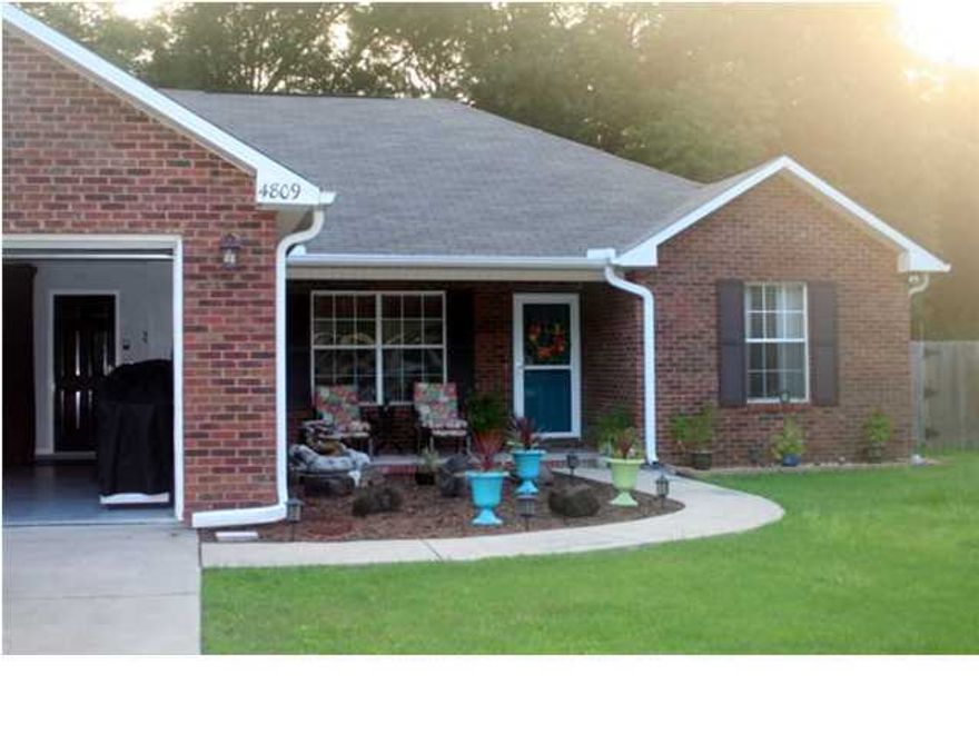 WELCOME HOME!!! No detail was missed in this beautiful 3bd/2ba brick split floor plan! Charming front porch welcomes you into the foyer with arched entry into the dining and kitchen featuring granite countertops, breakfast bar, maple cabinets with under cabinet and above cabinet lighting, microwave hood above the smooth top stove. Notice the attention to detail on the pantry and laundry room doors!! Spacious great room offers cathedral ceiling, crown molding and is wired for surround sound and opens onto the screened porch. The master suite with crown molding, terrific closet arrangement and makeup area in vanity is the perfect place to relax. The additional bedrooms have large closets with organizers and crown molding. The back yard is the perfect retreat with screened porch, down