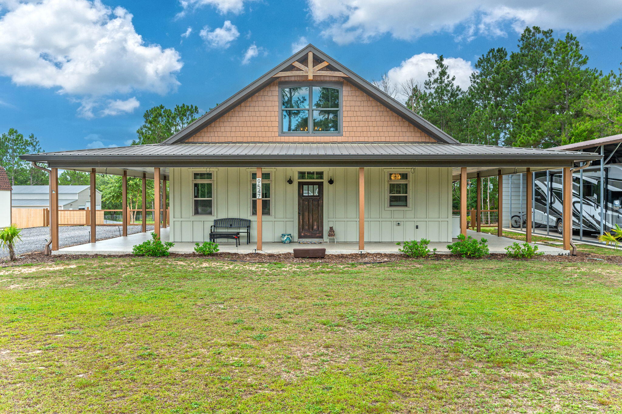 Country living at it's finest with this charming barndominium! As you walk up to the house you'll notice the wrap around porch that encompasses the whole house!  Sit outside & enjoy the outdoors from any side of the property!  This home features 3 rooms + a loft tucked away upstairs- you'll feel like a kid climbing up the wood ladder to your hideaway loft away from it all- you'll love the exposed wood beams & industrial vive of the exposed ductwork as well. You'll love the open concept as your walk in & your eyes will go straight to the gourmet kitchen featuring quartz countertops, tall maplewood cabinetry, soft close doors, stainless steel appliances & gorgeous fixtures. The main bathroom features a tiled walk-in shower with multiple shower heads & double vanities.