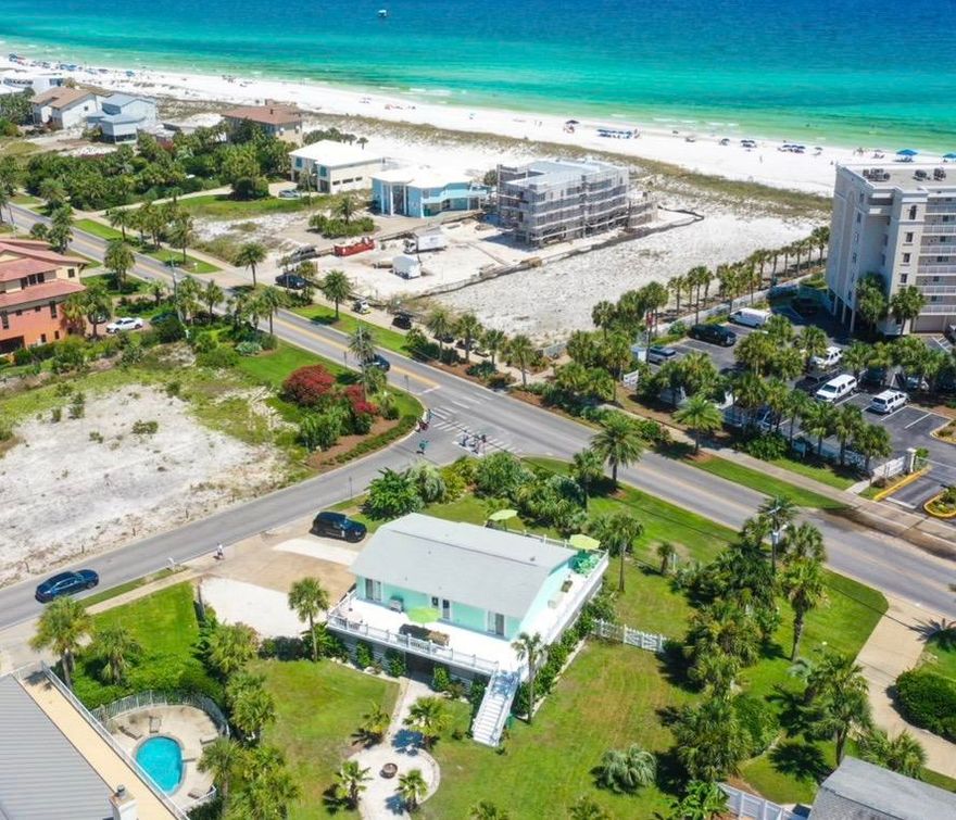 Rare property on Holiday Isle! One of the largest corner lots located steps from the beach and deep water canal access. Adjacent lot just SOLD for $1.2 million in May 2020. The dock can accommodate a 40' boat, there is currently a 26' boat there and a 6000 lb. lift. This 5 bedroom/ 3 bath house has the perfect floor plan with the main living upstairs and a downstairs with a 1/BR 1/BA lockout unit. This home has recently been renovated with new doors and windows throughout. Another great feature is the wrap around balconies, with access from the living room, kitchen and master bedroom. There is also a new 400 amp. box; 200 runs down to the dock (future plans to build the inland dock with 2 level dock house) other 200 for the home. The outdoor Hvac units replaced 3 yrs ago. 24 Palms added