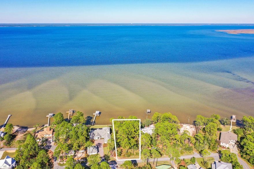 Exceptional opportunity abounds with this primely positioned homesite on Paradise Point in the heart of Santa Rosa Beach yielding an impressive 130' of linear footage on the Choctawhatchee Bay totaling .84 acres. Notable improvements include a recently built seawall and rip-rap for optimal protection. This pristinely maintained property would be an excellent site for a second home or primary residence with private yet convenient location offering close proximity to Sacred Heart Hospital as well as Grand Boulevard and subsequent world class shopping, dining & entertainment. Paradise Point is positioned with easy ingress and egress to highway 98 including close proximity to the beaches of Scenic Highway 30A as well as access to all of the commercial infrastructure in Destin & Miramar Beach.