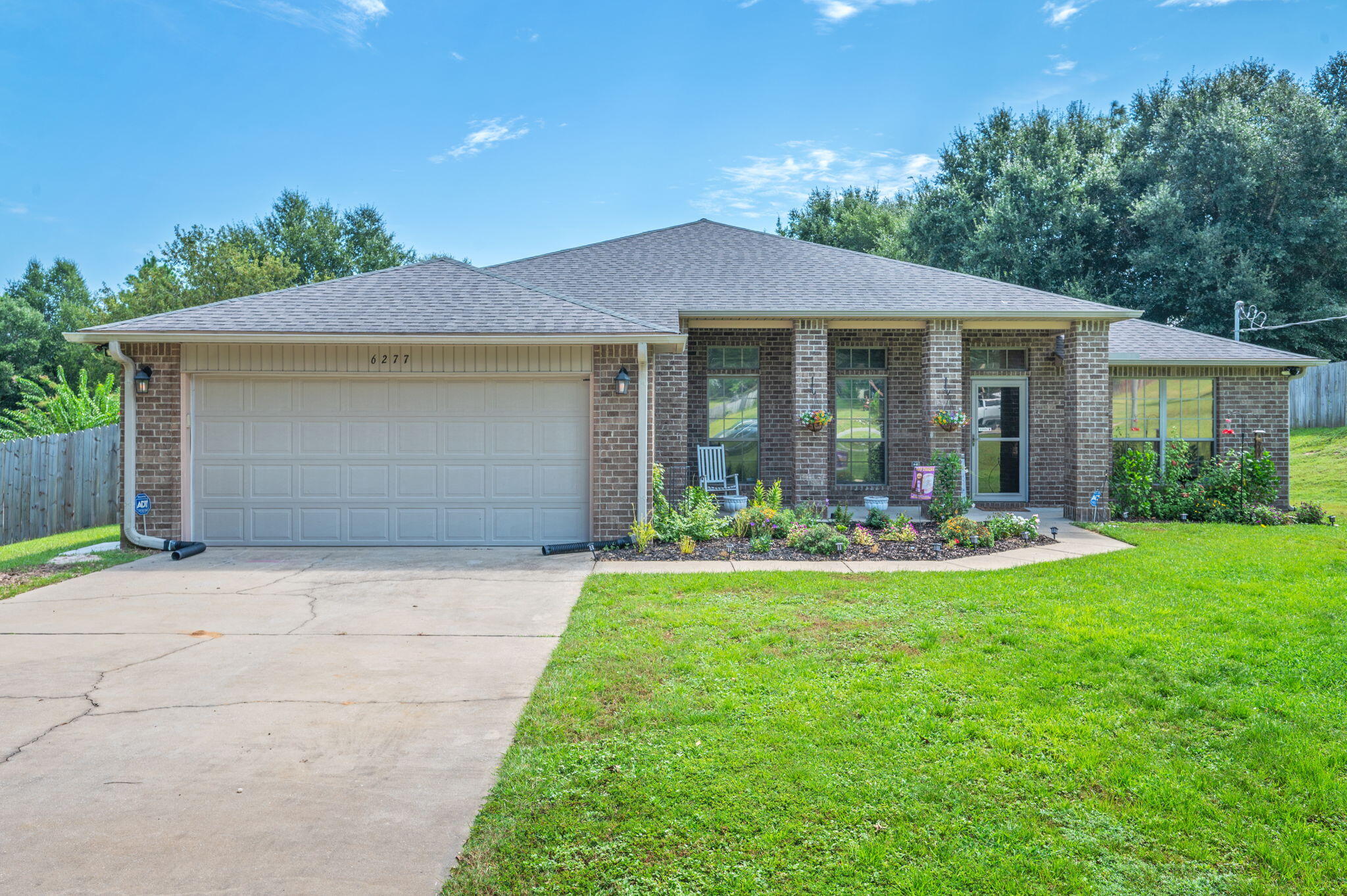 All-brick beauty on a half-acre lot! Welcoming front porch opens to a lovely split-floor plan with 10' ceilings and no carpet-just stylish LVP & tile. Spacious kitchen with mahogany cabinets, granite counters and generous storage flows easily for gatherings. The large dining room and private office/study add flexibility. Retreat to a serene primary suite w spa-like bath, garden tub, & separate shower. Bedrooms 2&3 share a convenient Jack & Jill bath! Relax in the screened porch, enjoy the fenced backyard, and take advantage of the 10x22 shed. A home that blends comfort, charm, and everyday convenience.