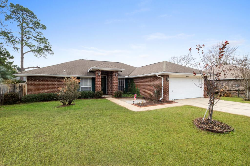 This beautiful all-brick 3-bedroom, 2-bathroom home is nestled in Cotton Bay Estates in Navarre. Situated on a 0.20-acre lot in a quiet cul-de-sac, it offers a peaceful setting with minimal traffic--perfect for families and a safe space for kids to play.Inside, you'll find a semi-open floor plan with vaulted ceilings in the living room, seamlessly connecting to the dinette and kitchen. Just off the entryway, a dedicated office or flex room with French doors sits to the left, while a formal dining room on the right provides convenient access to the kitchen.The two additional bedrooms are spacious enough to accommodate queen-size beds, while the primary suite is privately located on the opposite side of the home. The ensuite bathroom features dual vanities and an updated, oversized tiled shower.

Step outside to enjoy the wooden deck overlooking a private, landscaped backyard, offering plenty of space for entertainingor even your future pool.