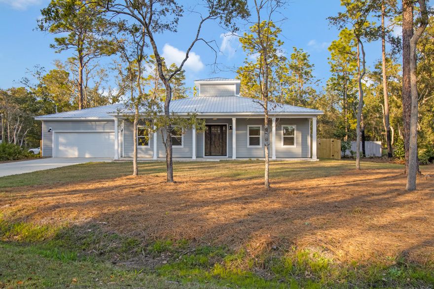 Gorgeous custom built 3 bedroom, 2 bath home in a mature neighborhood close to the water is one of a kind boasting exquisite finishes including hardyboard siding, 1000 square feet of covered porches with tongue & groove ceilings stained to match the custom front door, custom showers with penny tile, Delta fixtures, built-in Roomba storage & charger, farmhouse lighting fixtures, farmhouse kitchen sink, tongue & groove accent walls, soft close cabinetry, 10' farmhouse doors, interior trim, custom windows, 12' garage with shop lighting, keypad entry system, privacy fenced back yard, lawn sprinkler, remote control interior lighting, metal roof by Solid Roofing, Inc., granite counter tops, and a crows nest built for energy efficiency.  Close to shopping, schools, and entertainment.
